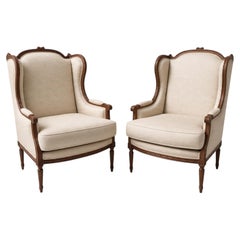 Pair of Louis XVI Style Carved Walnut Wingback Bergere Armchairs, France