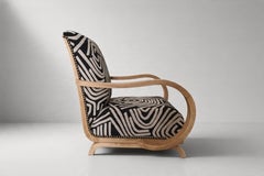 Fauteuil Art déco aux accoudoirs courbés, bois blanchi, revêtement à motifs graphiques, années 1930