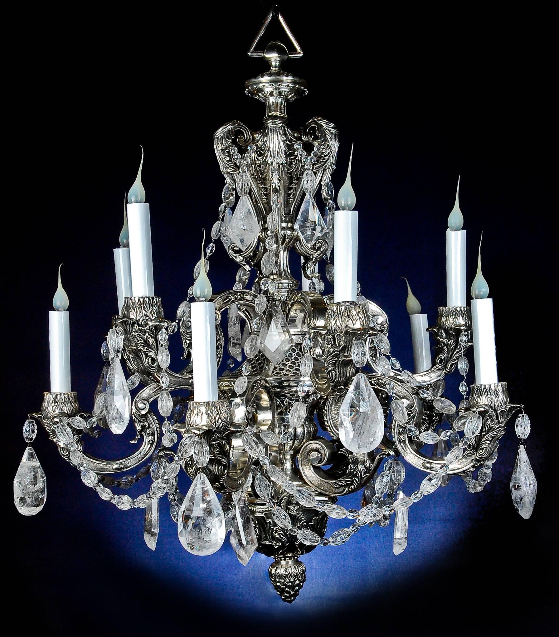 A fine antique French Louis XVI style silvered bronze, cut rock crystal and cut crystal multi light double-tier chandelier embellished with large cut rock crystal prisms and cut crystal chains.