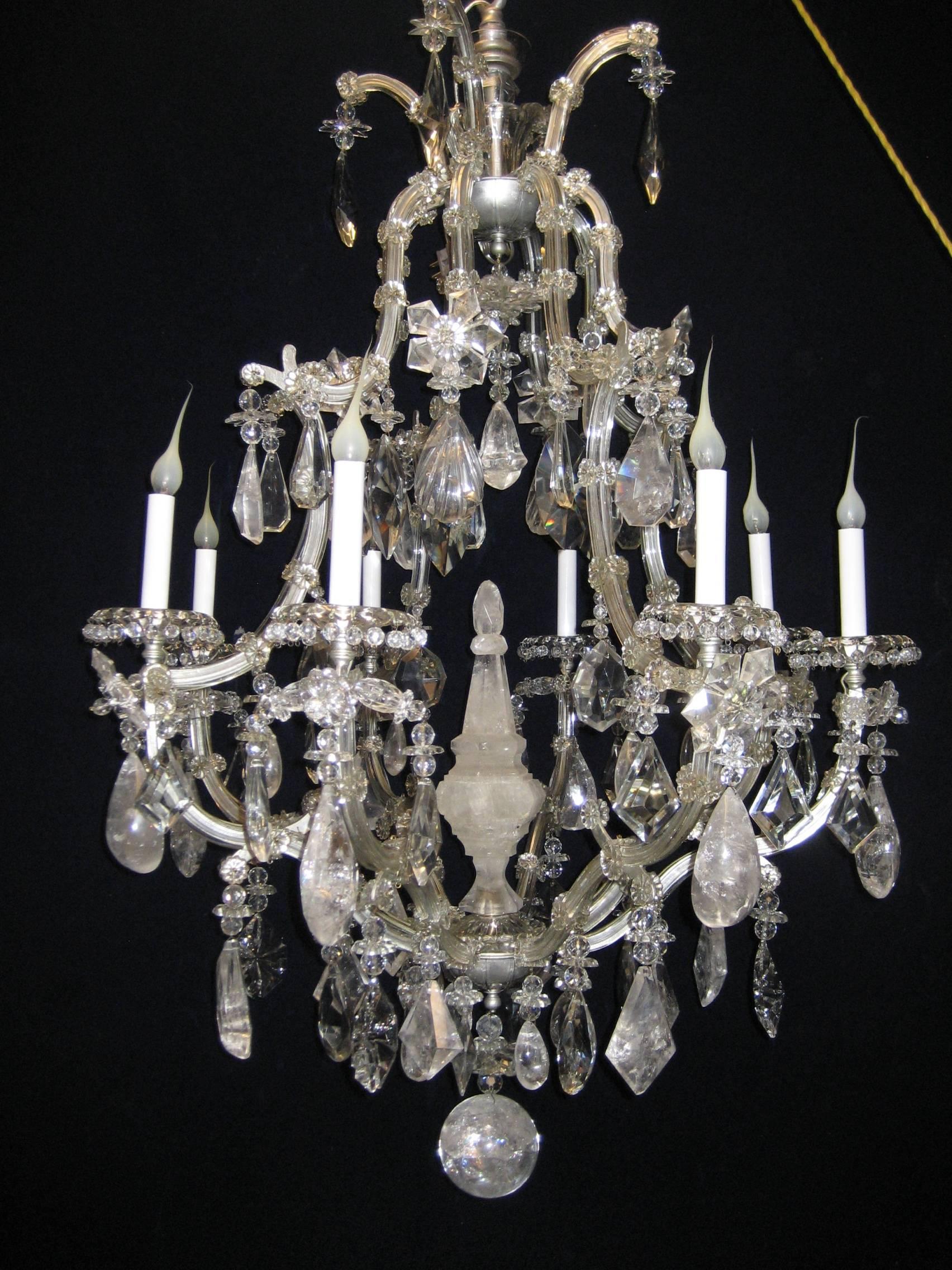 A fine large antique French Louis XVI style silvered bronze, cut rock crystal, glass and crystal multi light cage form chandelier of great detail embellished with cut rock crystal prisms, glass arms, crystal prisms, cut rock crystal flowers and