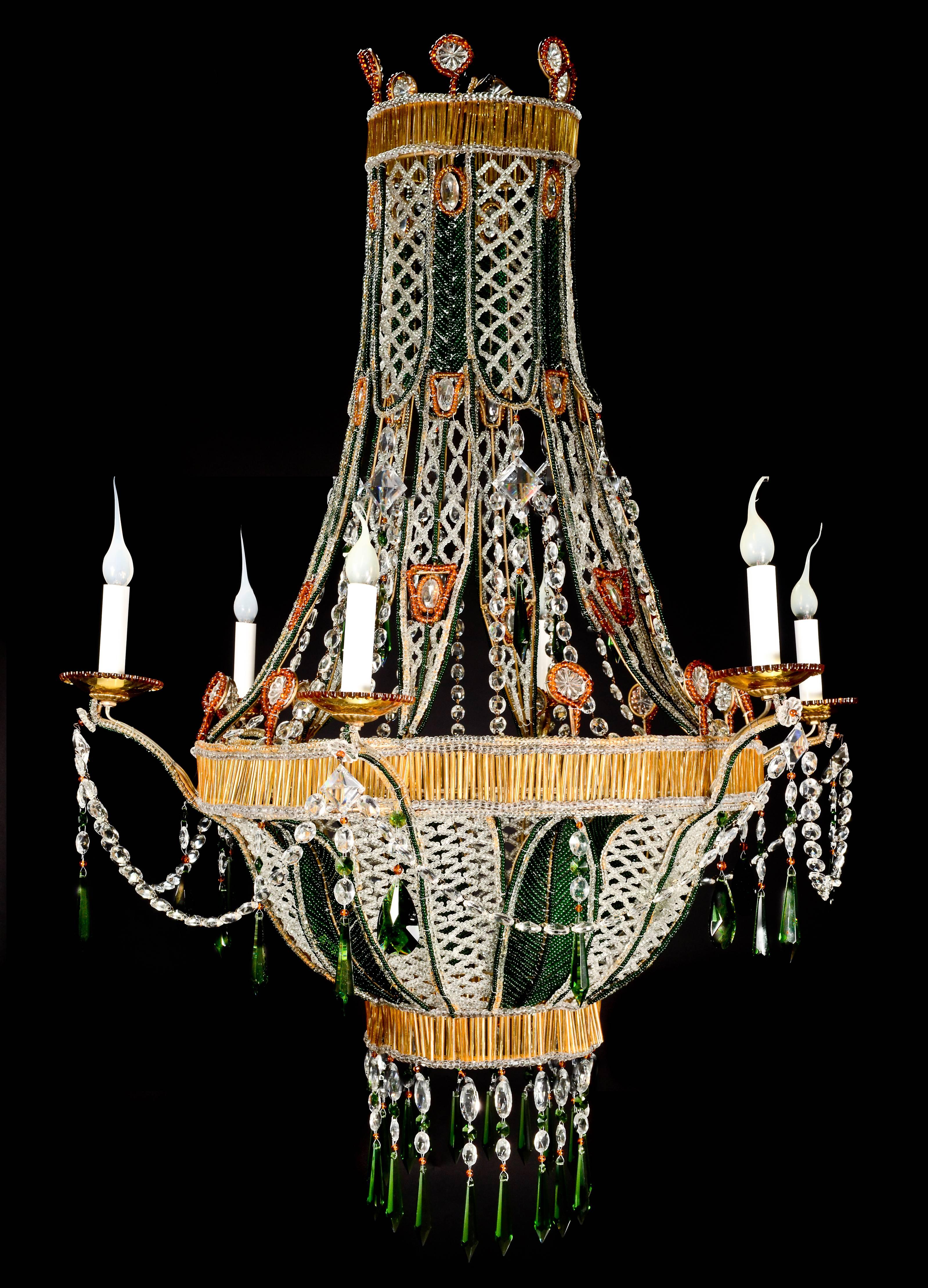 A unique Italian Louis XVI style amber glass, cut crystal, beaded glass and emerald green glass chandelier of exquisite detail embellished with cut crystal chains and prisms.