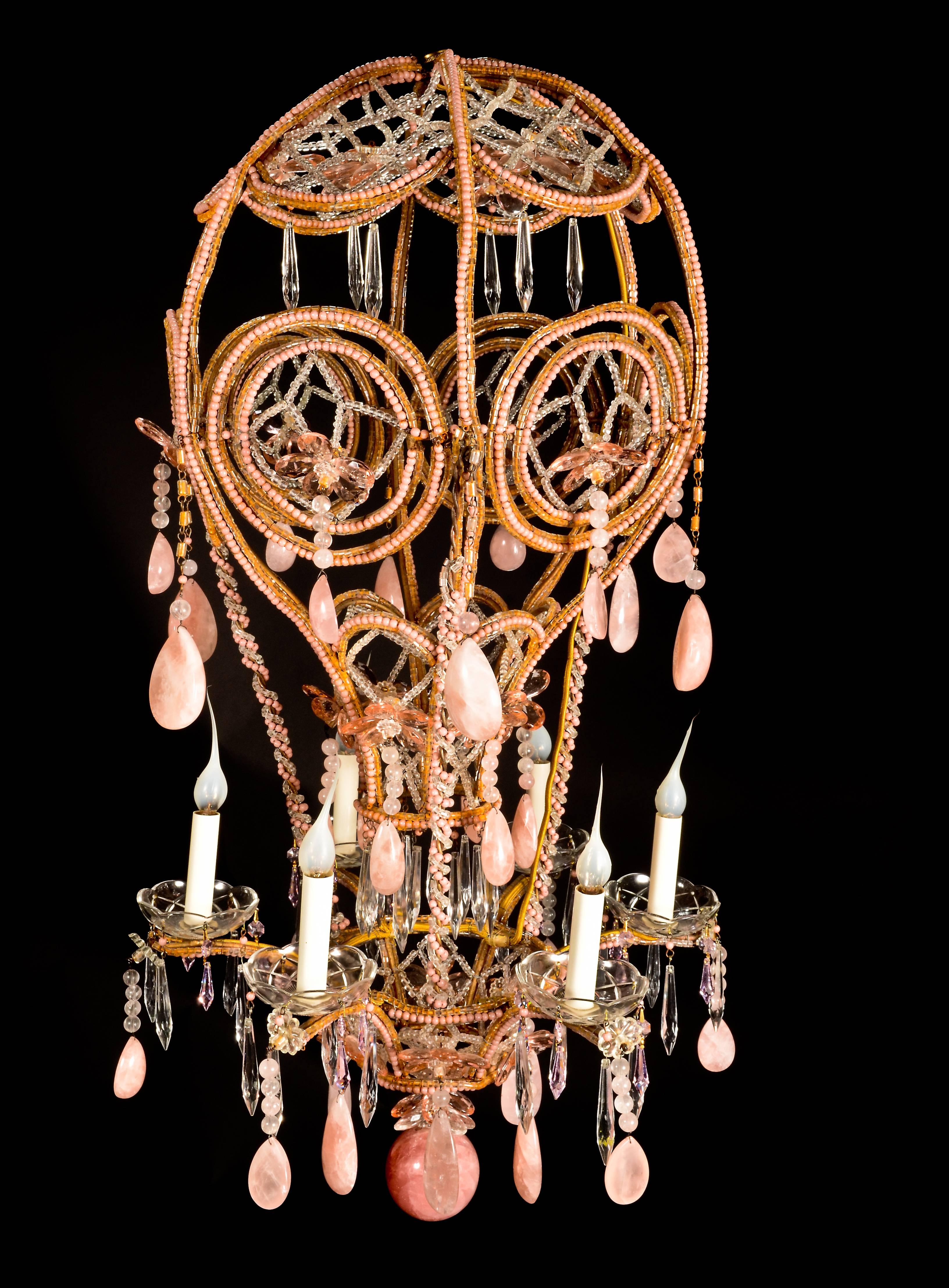A superb antique French Louis XVI style pink rock crystal hot air balloon chandelier of great detail embellished with cut pink rock crystal prisms, beaded glass, crystal prisms and a central pink rock crystal ball in the style of Bagues.