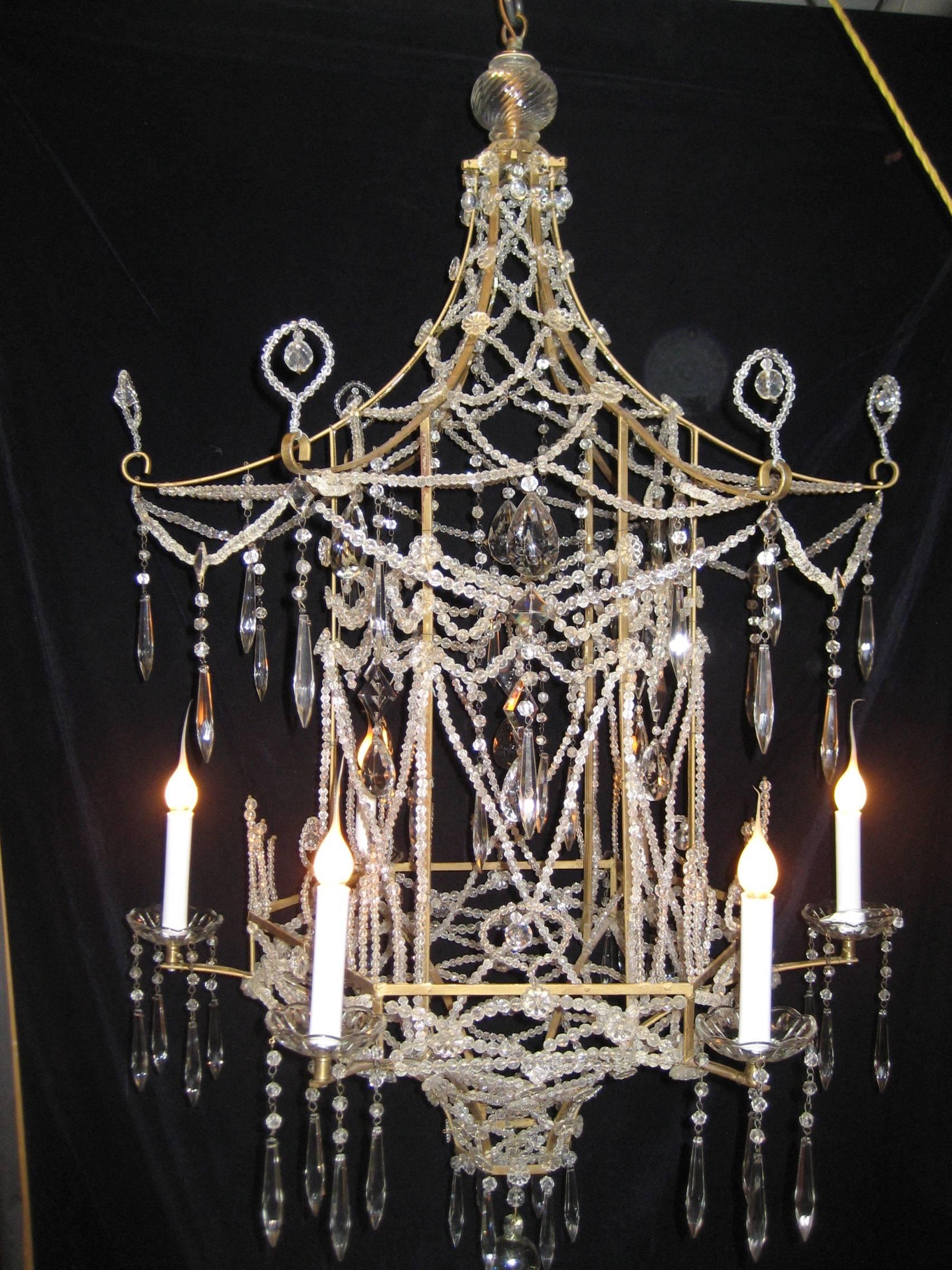 A rare Italian multi light chinoiserie style pagoda form bronze, cut crystal and beaded crystal chandelier of great detail embellished with crystal chains and prisms.