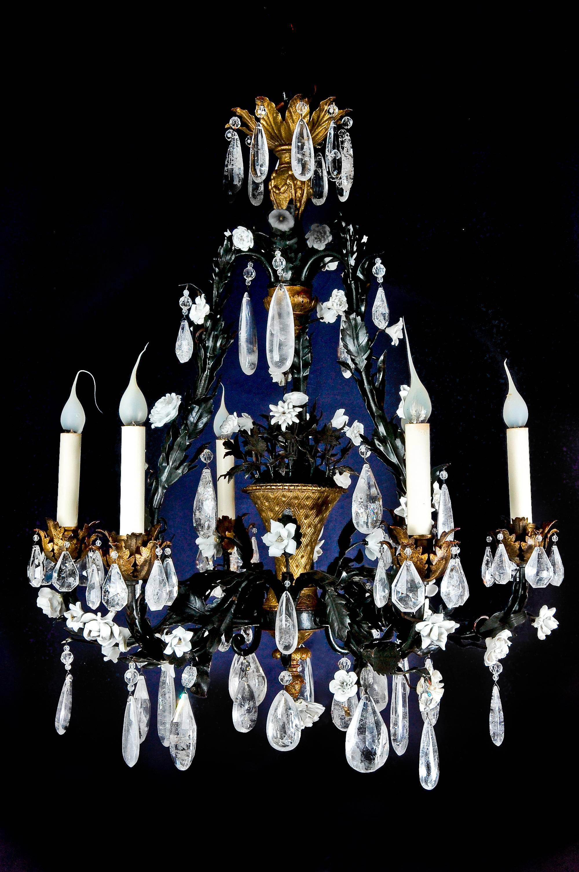 A superb antique French Louis XVI style gilt bronze, tole, rock crystal and porcelain floral chandelier embellished with cut rock crystal prisms, tole leaves and porcelain flowers.