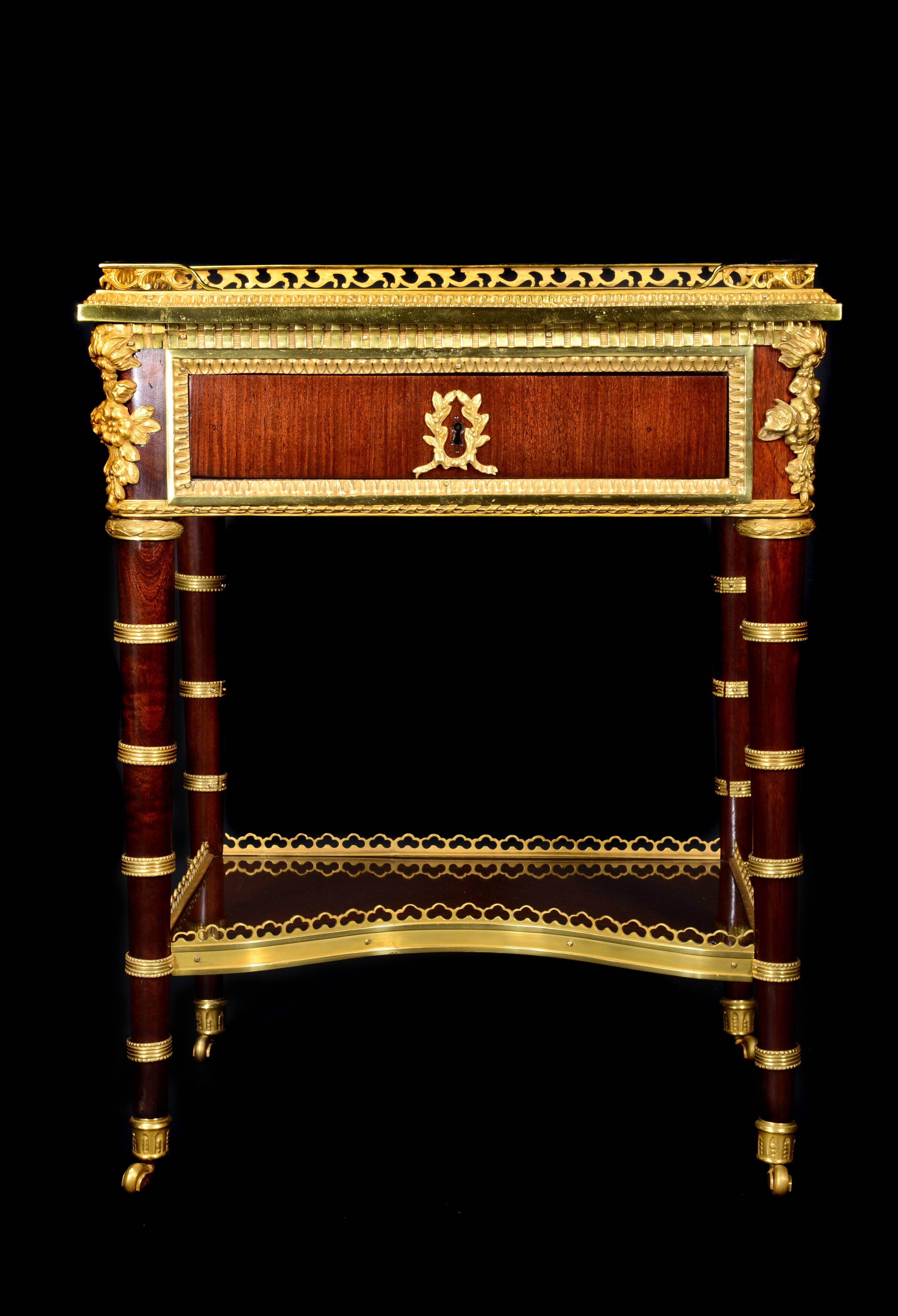 A pair of exquisite antique French Louis XVI style gilt bronze-mounted mahogany single drawer side tables of superb detail embellished with gilt bronze mounts and decorated all the way around.