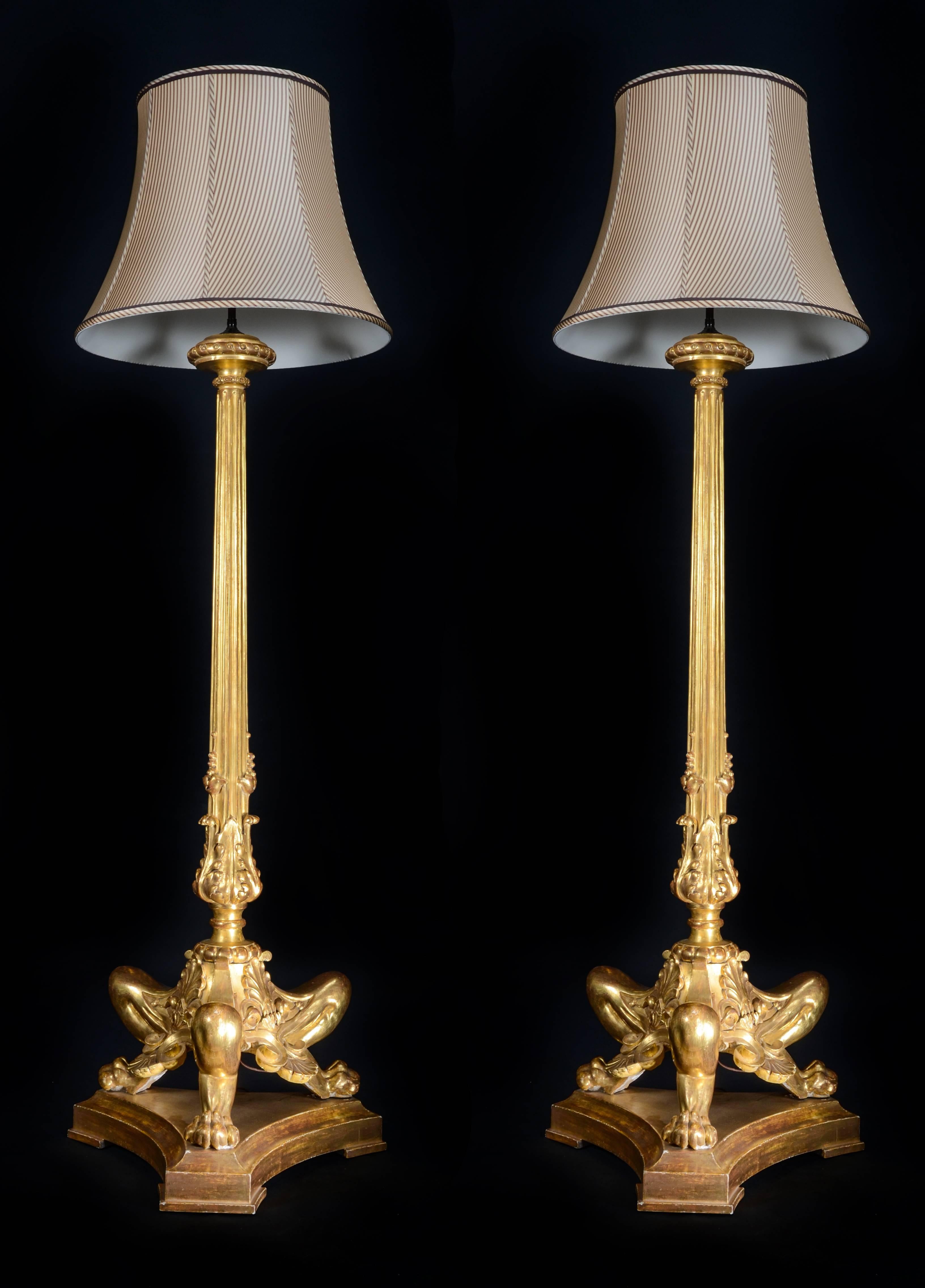 A pair of fine antique French neoclassical style carved giltwood floor lamps.