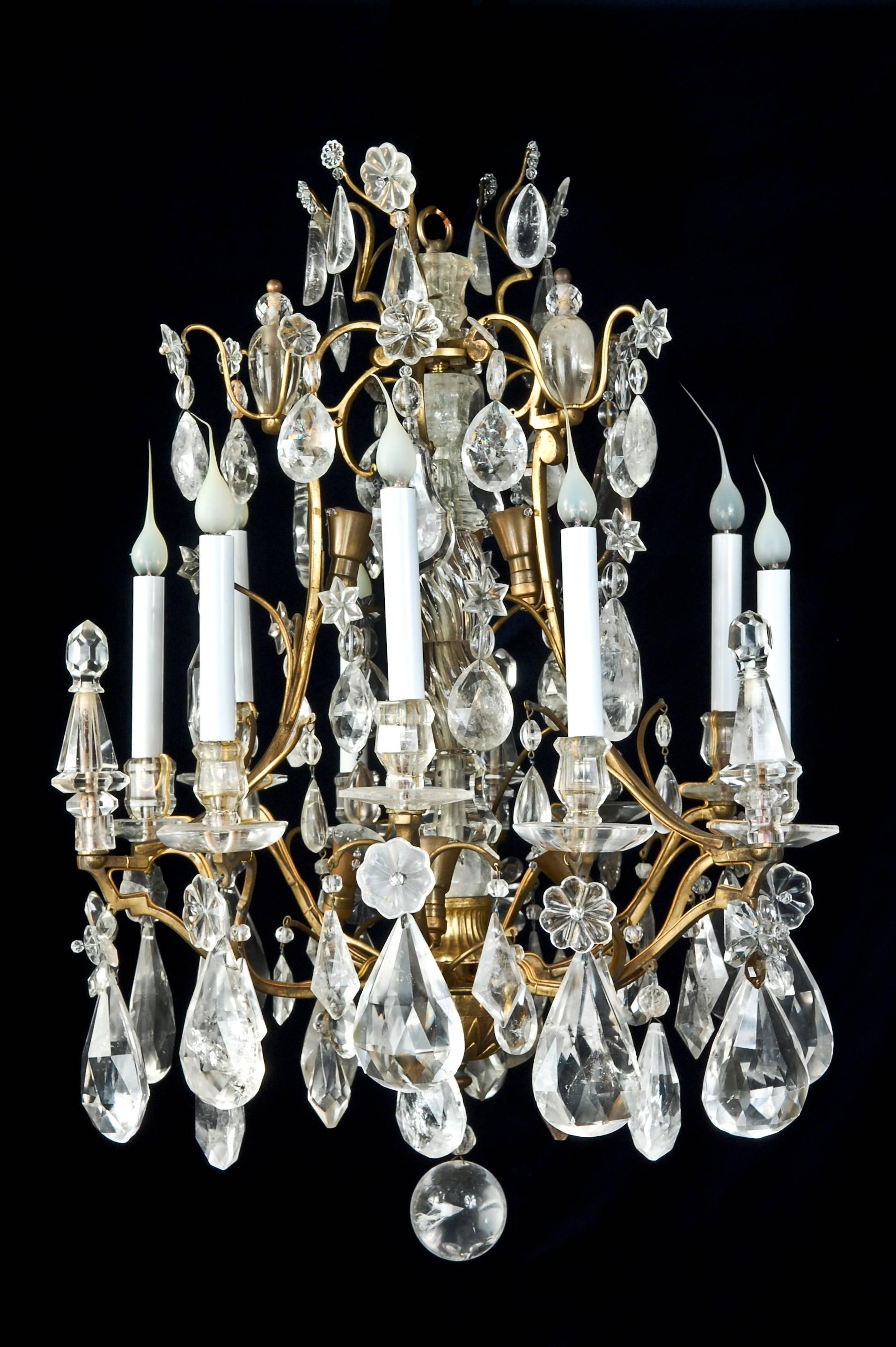 A pair of fine antique French Louis XV style cage form gilt bronze and cut rock crystal chandeliers in the style of Bagues.