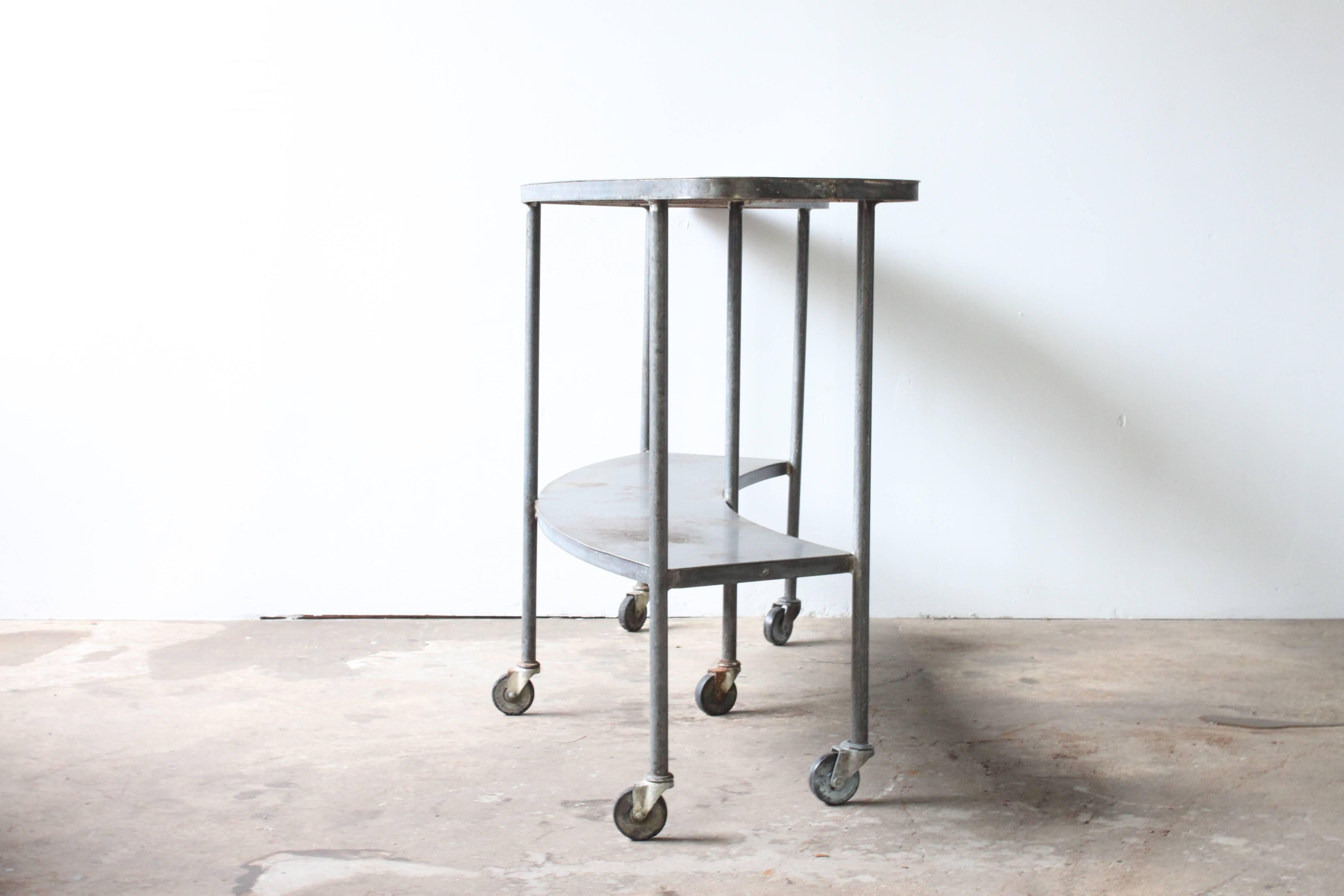 Curved Industrial table on casters.