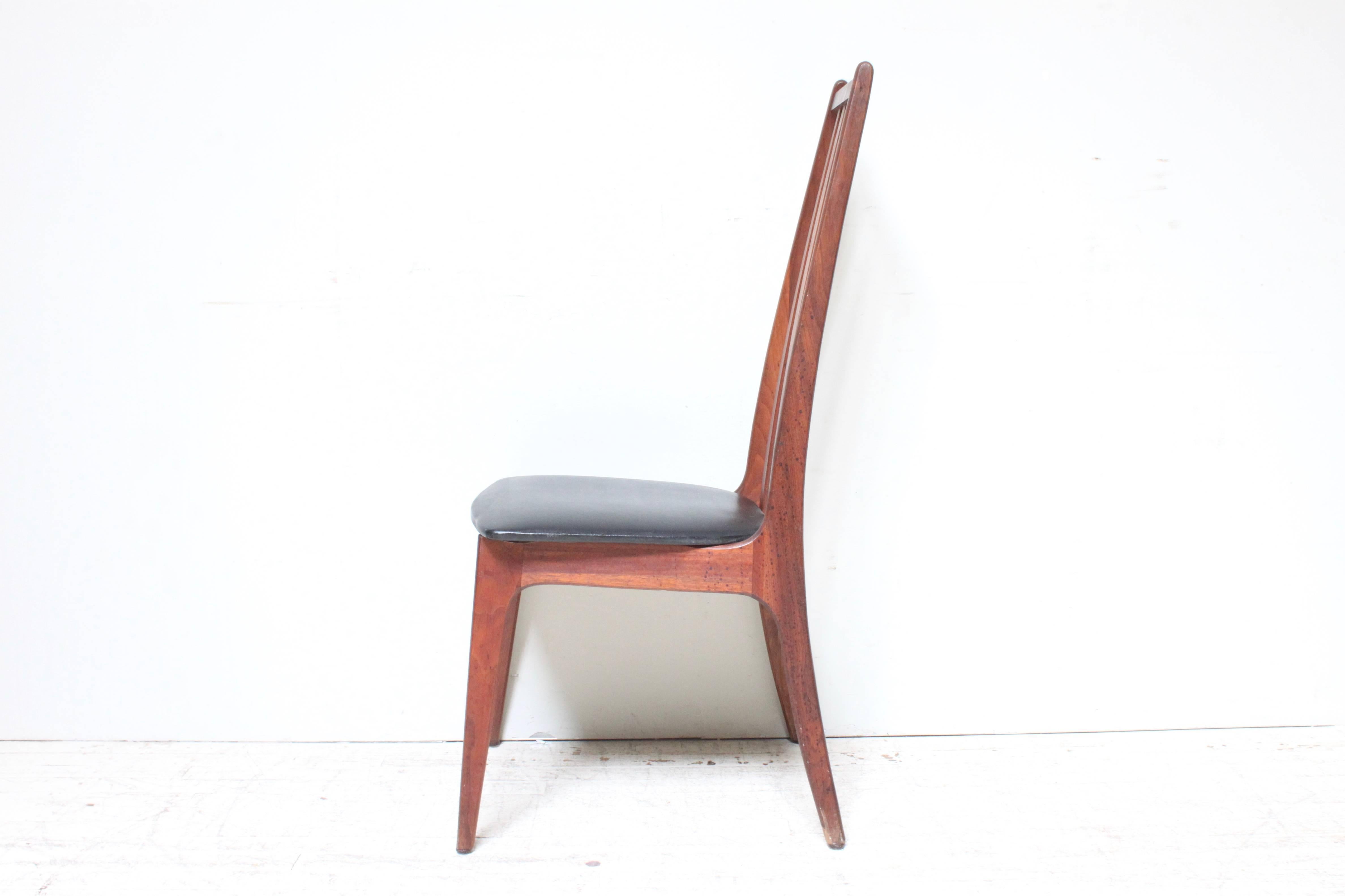 Beautiful walnut high back dining chair very often attributed to Adrian Pearsall. Original vinyl seat pad in good condition. Solid black Walnut frame is in good original condition as well.