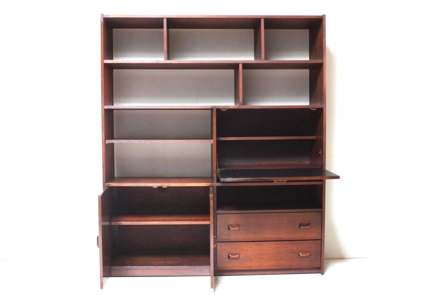 A very nice walnut wall unit with a drop front bar/secretary desk on right. Among a generous amount of open shelf space is a cabinet on the lower left with two drawers on the right.