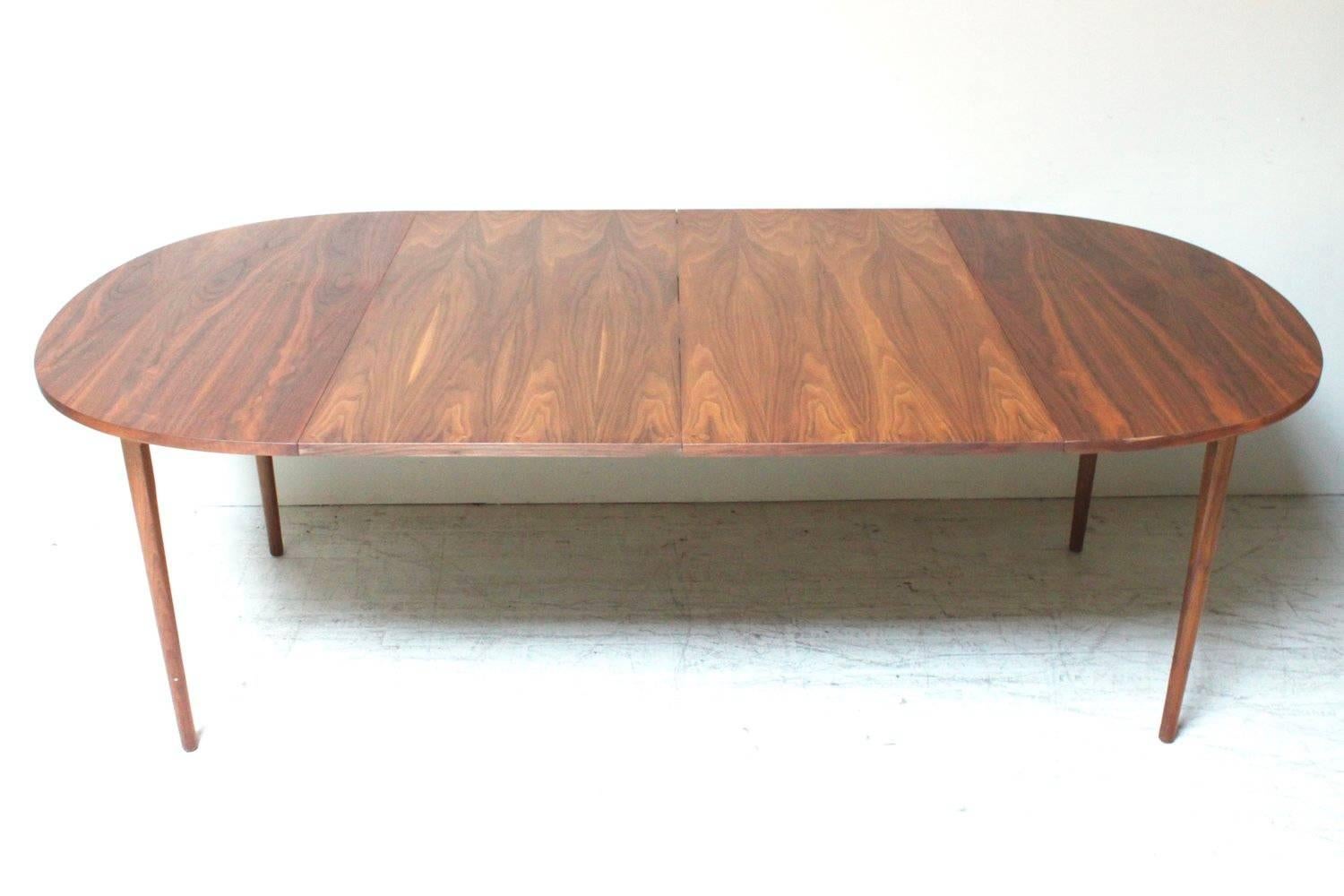 This is a stunning warm walnut circular dining table with two 22