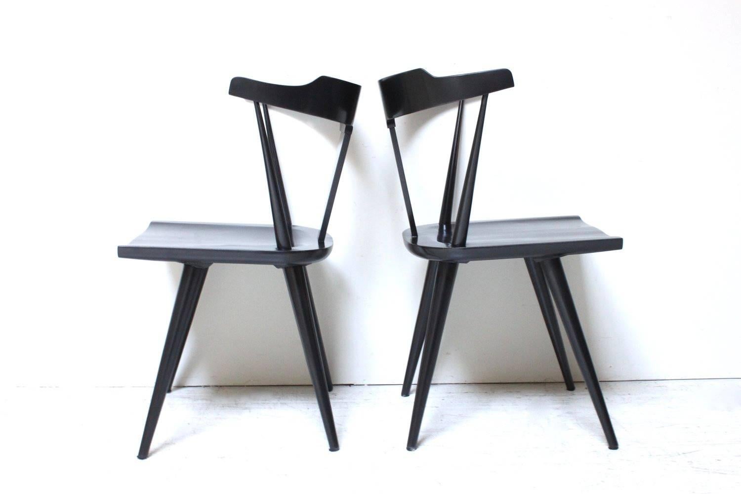 A beautiful pair of Planner group dining chairs in black lacquer.