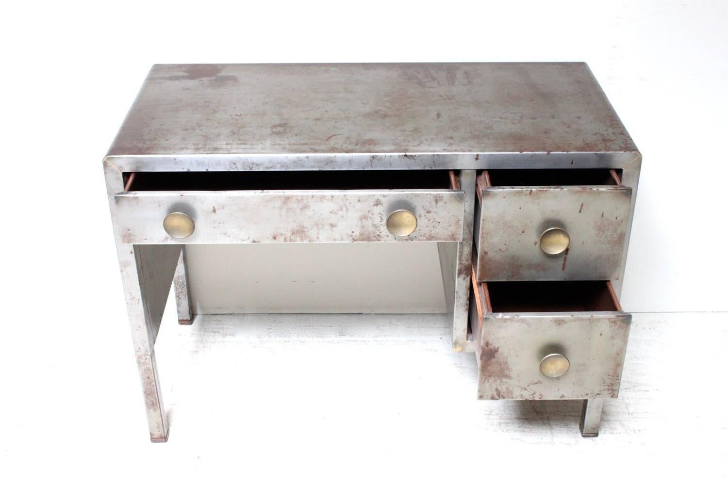 A perfectly patina example of the famous desk designed by Norman Bel Geddes for Simmons in the 1930s.