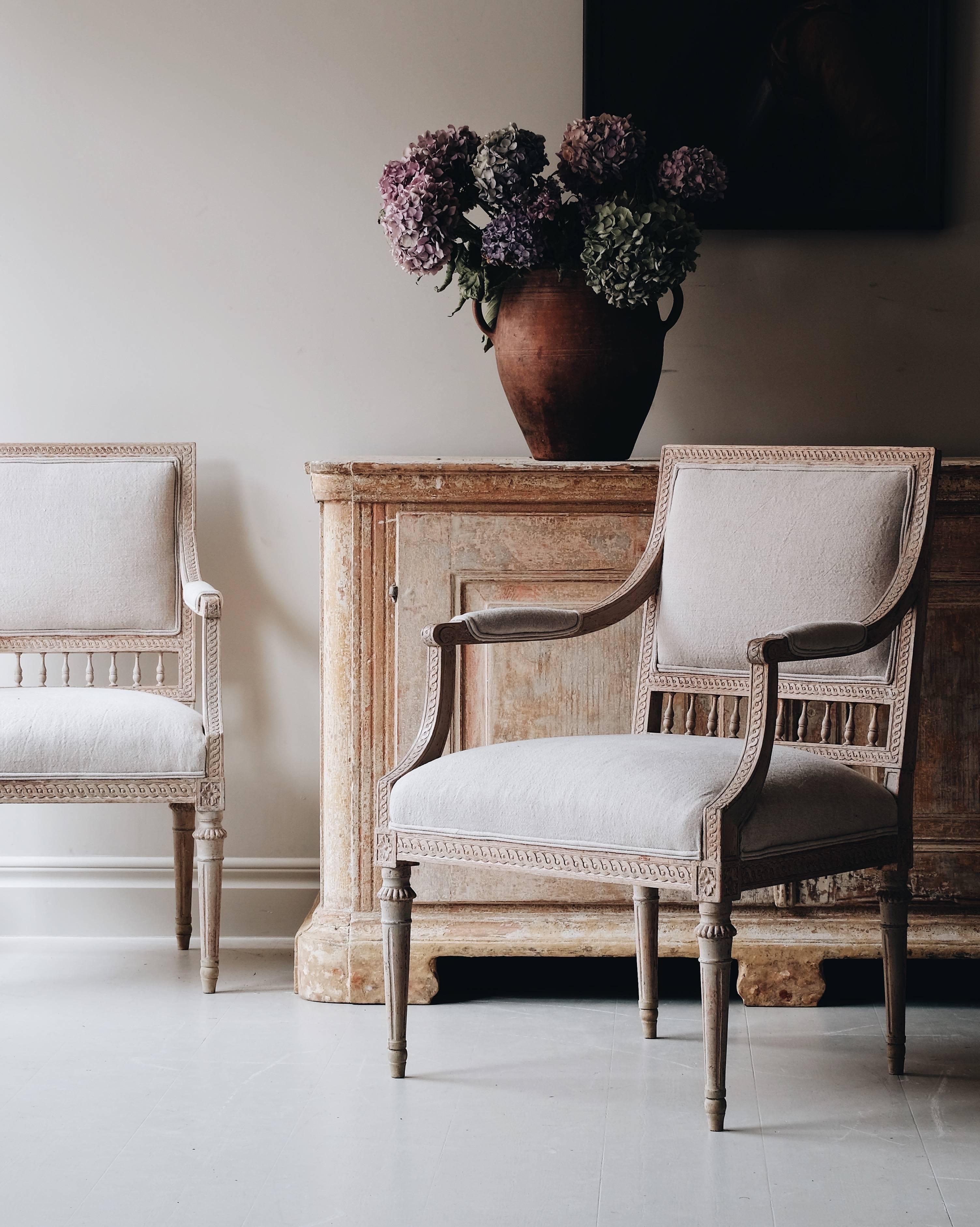 Exceptional pair of 18th century Swedish Gustavian armchairs in original color with fine guilloche carvings and proportions, circa 1790, Sweden.



