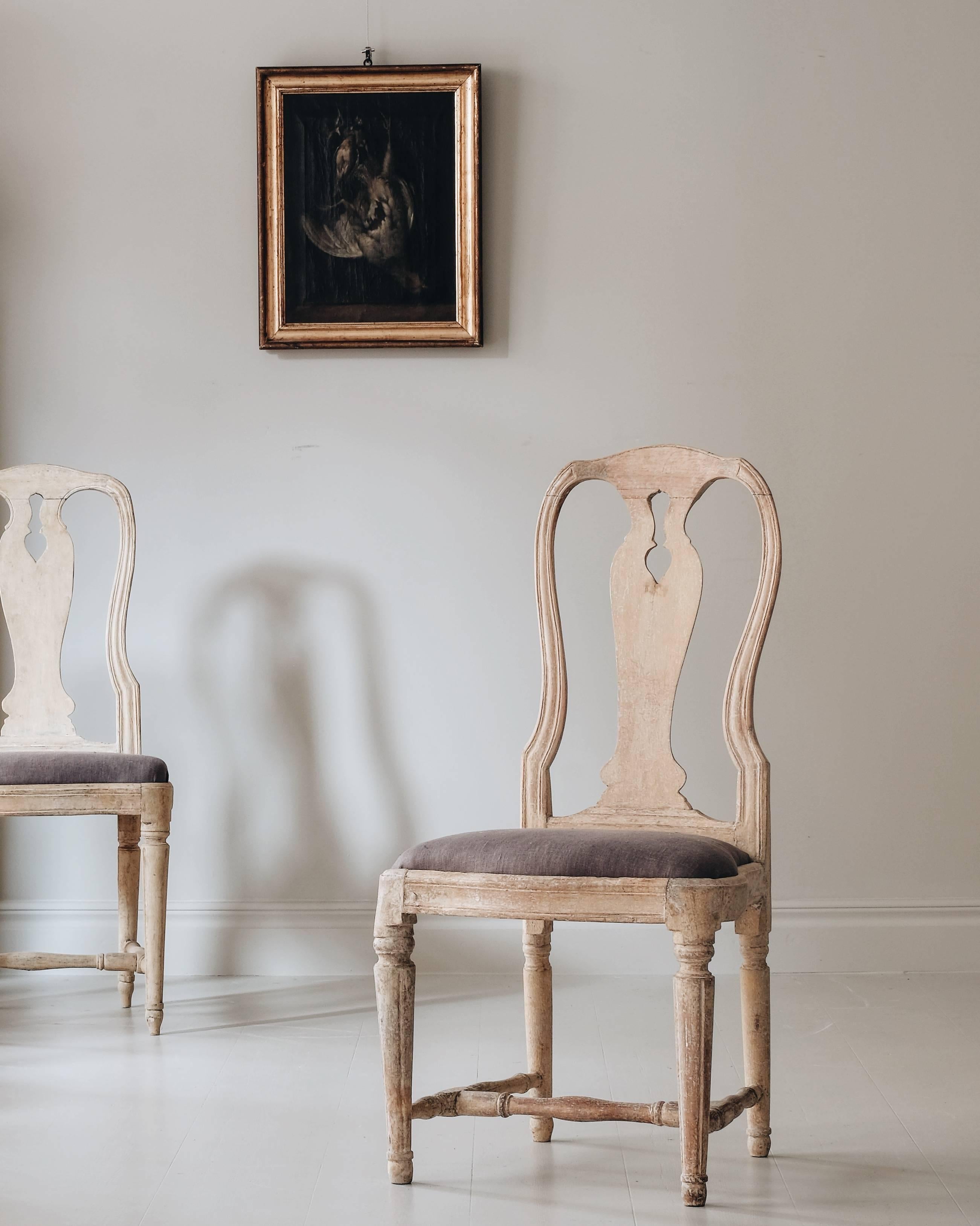 Remarkable and rare set of twelve 18th century matched transitional Rococo - Gustavian dining chairs in original colour. Ca 1775, Stockholm Sweden.

The rococo back with it’s curved crest, uprights and elegant baluster splat, combined with the
