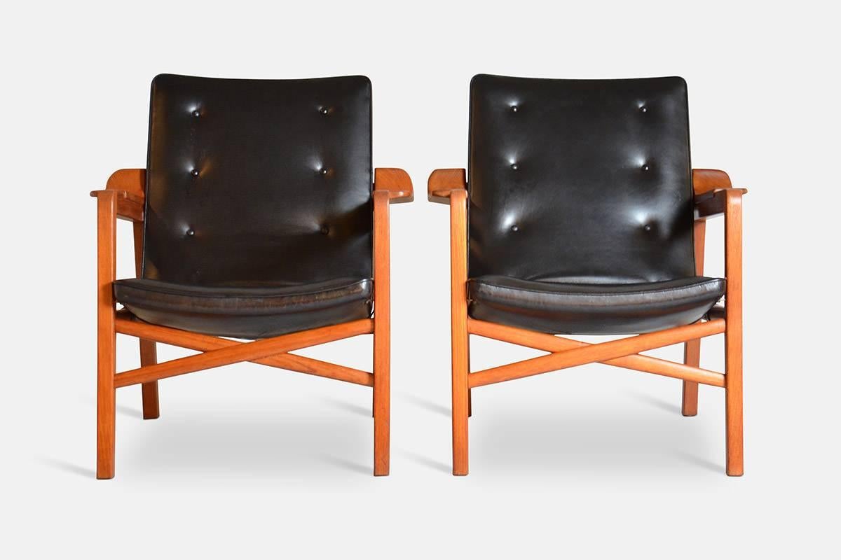 Tove Kindt-Larsen (1906-1994) and Edvard Kindt-Larsen (1901-1982).

A pair of fireplace chairs, produced in teakwood, upholstered in original black leather, fastened with buttons covered in leather. Designed in 1939. Produced by master