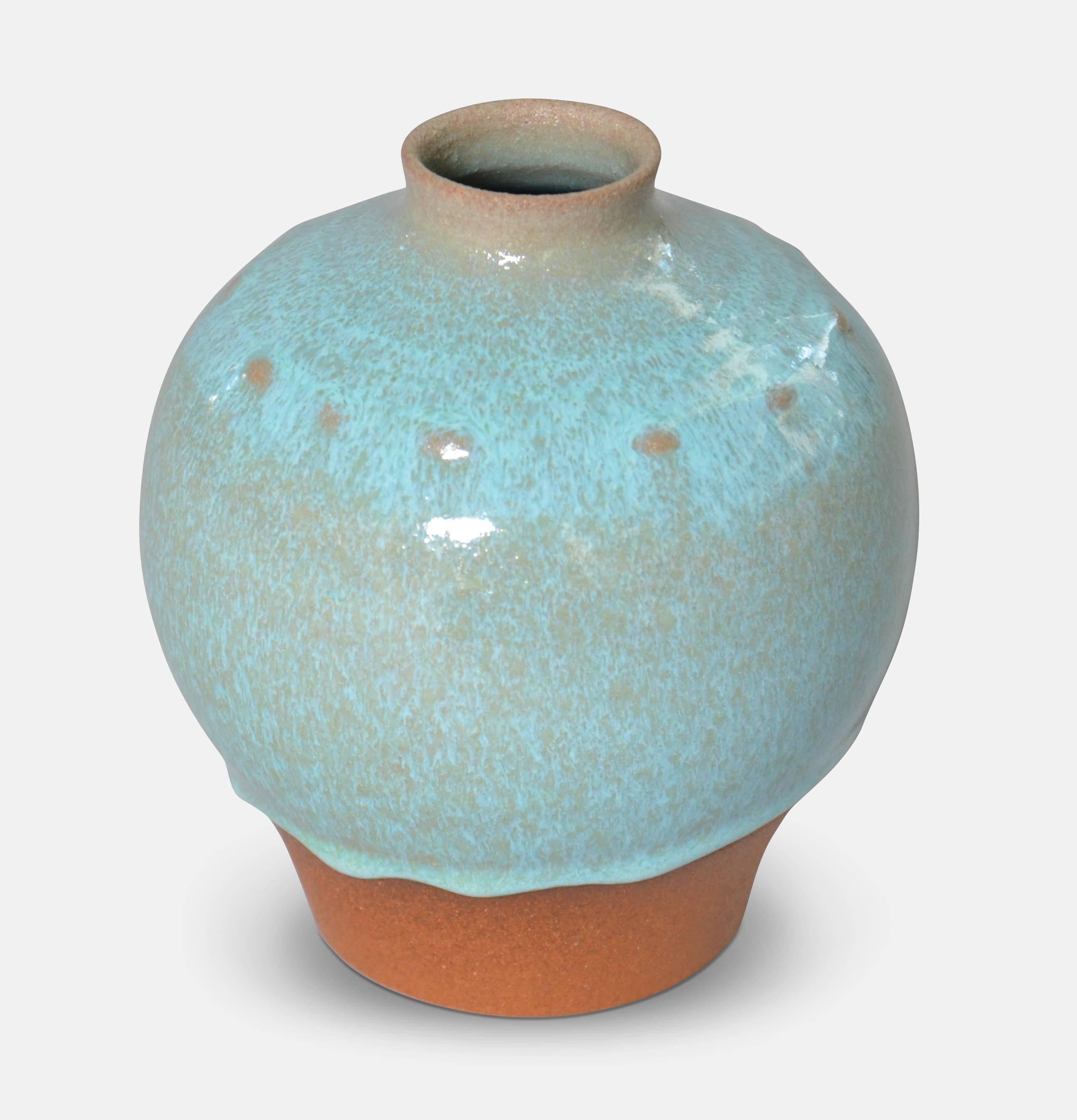 Christian Poulsen (1911-1991).
Round vase with dots and running blue glaze. 
Signed 