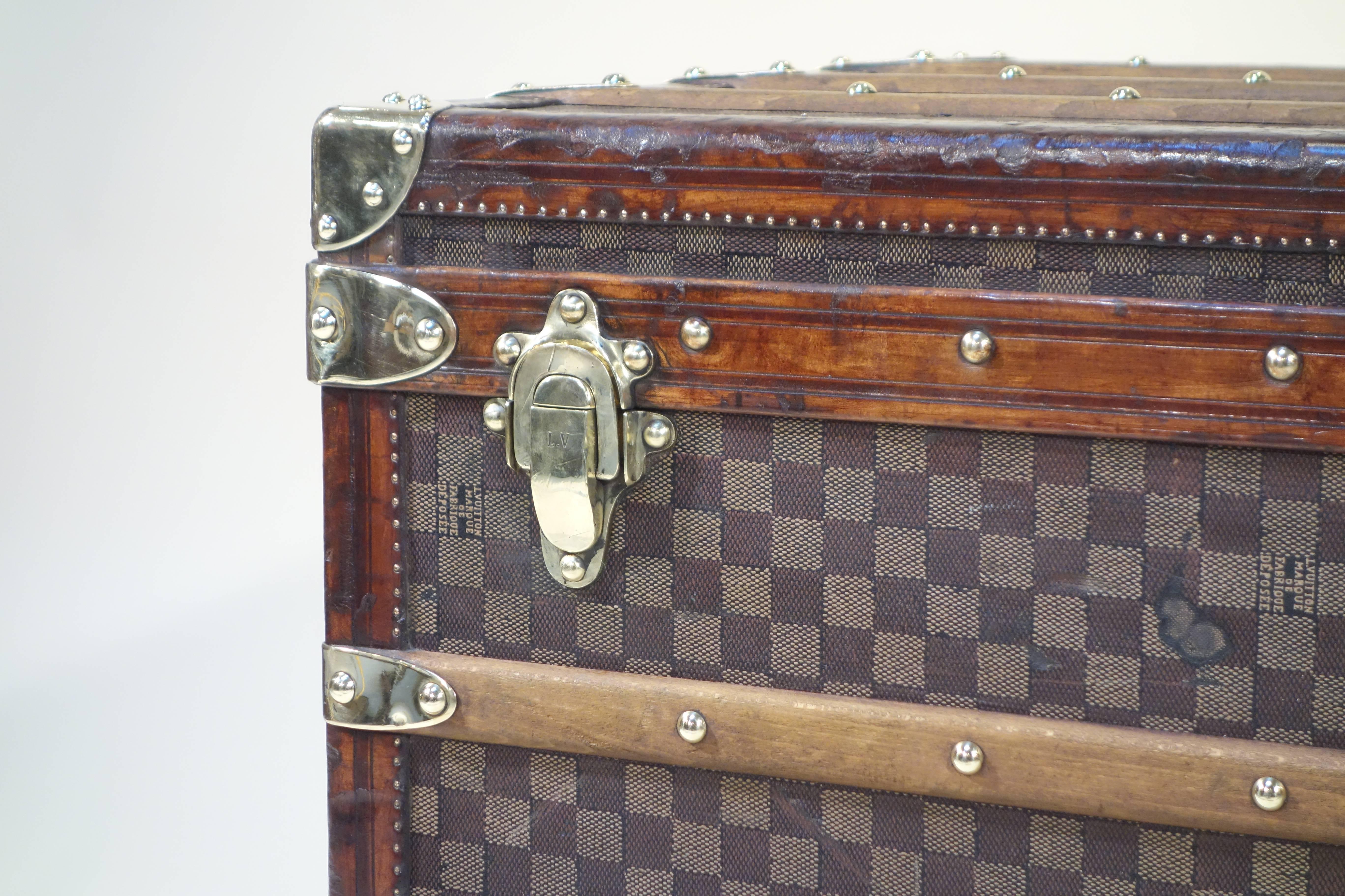 
Louis Vuitton Steamer damier trunk, special year. 
 Anniversary Special, 1789.
Louis Vuitton create this type of trunk decorate with red white blue ribbon for the centenary of the French revolution in 1889.
This is a trunk in first series,