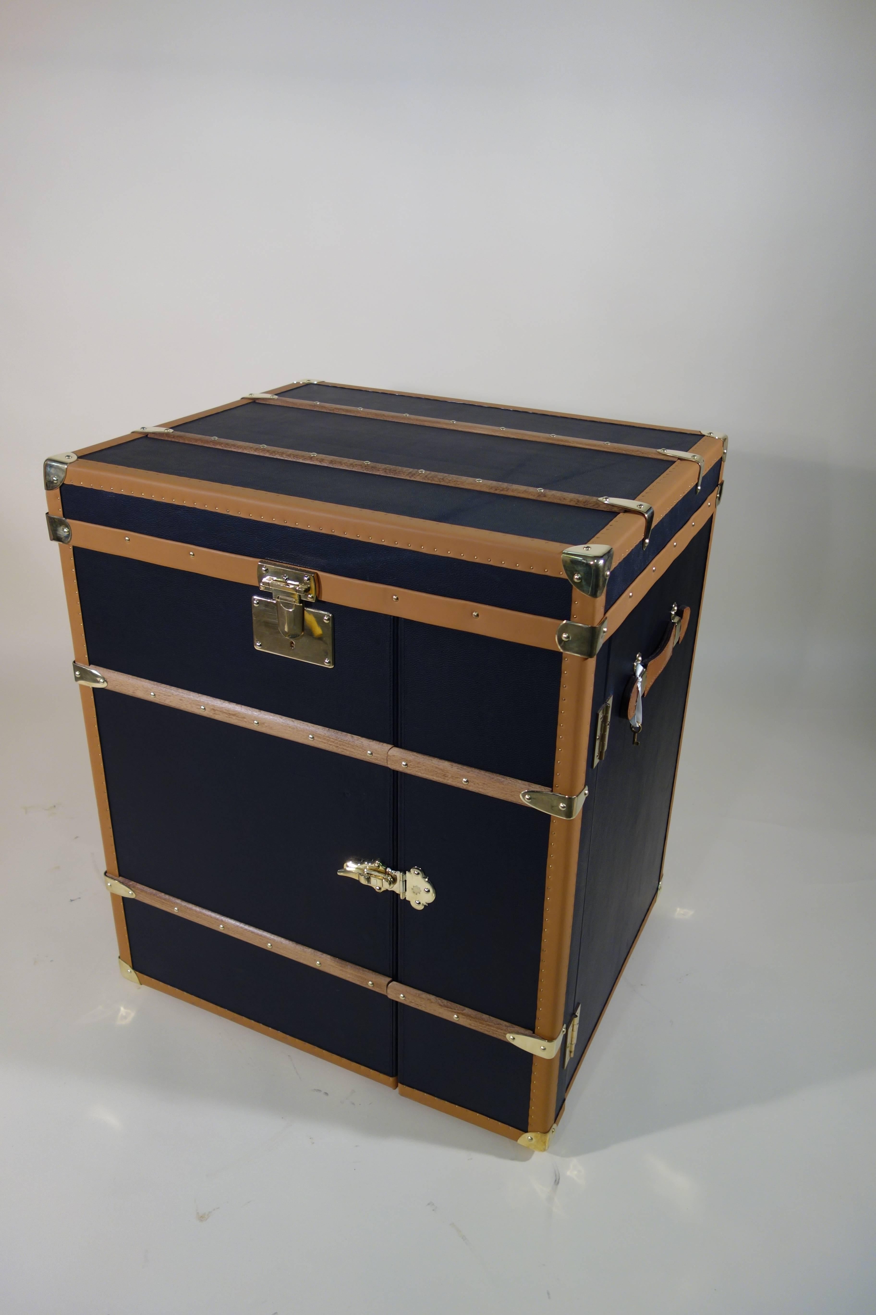 Special order office trunk.

Single piece.

Bijouterie solid brass.

Black leather.

Leather border.

Interior suede wrapped.

Leather handles.

The trunk has three drawers, the side door and left two drawers.

You can introduce an