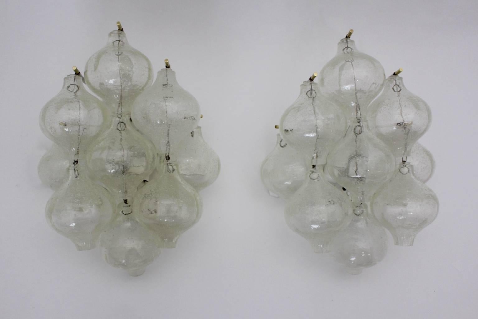 A beautiful timeless pair of mid century modern Tulipan sconces by J. T. Kalmar executed by Kalmar, Vienna, 1960.
Paper label on the backside.
Nine handblown glass bubbles are mounted on a white enameled metal frame with brass details.

The sconces
