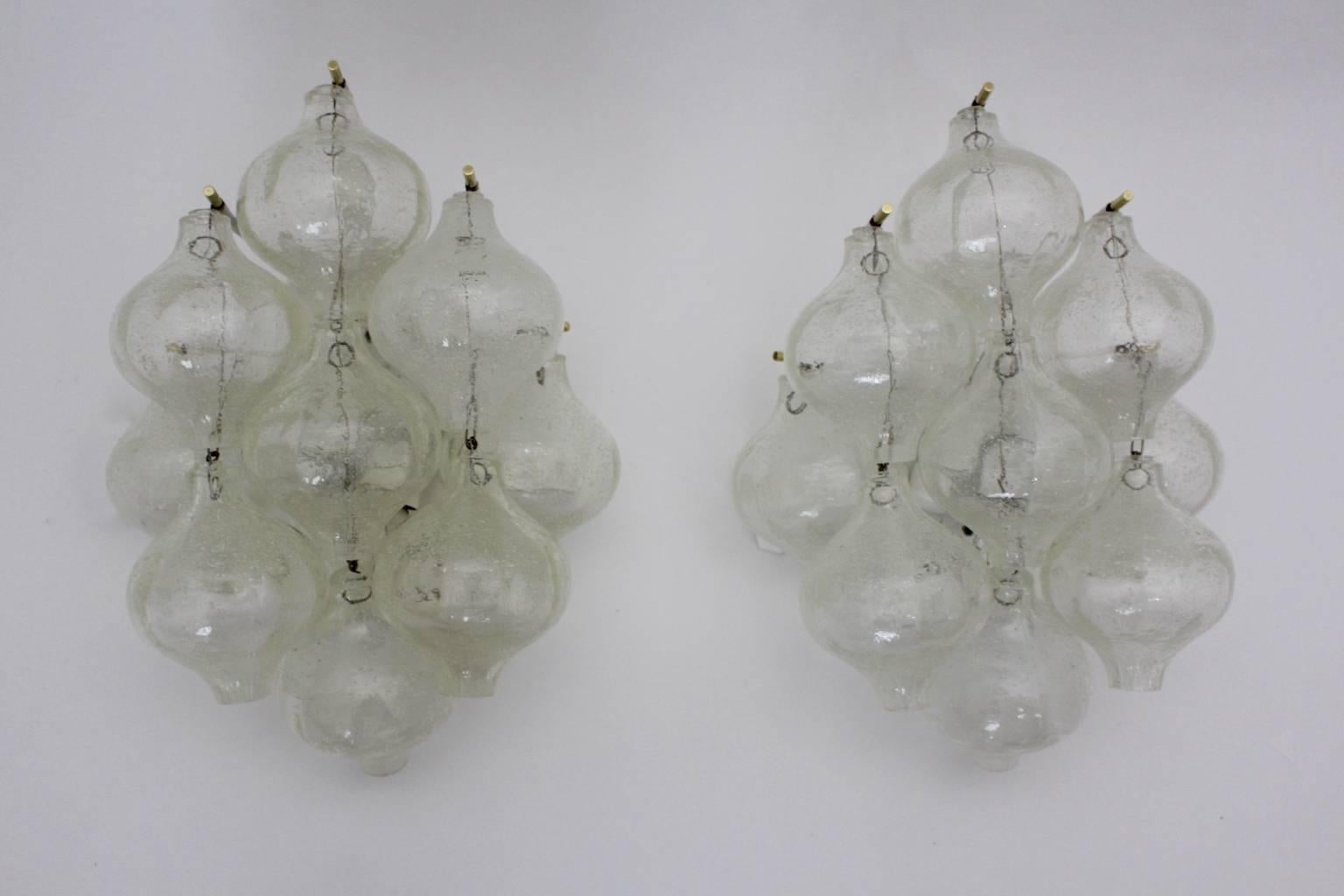 Mid Century Modern vintage beautiful timeless pair of sconces wall lights model tulipan by J. T. Kalmar executed by Kalmar, Vienna, 1960.
Paper label on the backside.
Nine handblown glass bubbles in beautiful rounded organic shape are mounted on a