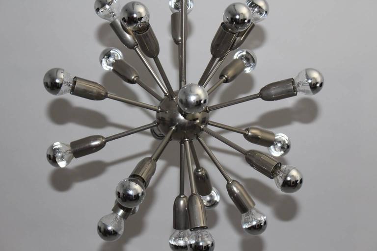 Mid Century Modern nickel-plated metal Sputnik chandelier with 21 arms, which was designed 1960s Italy.
Metal sockets with round chromed bulbs E 14.

Measurements:
Diameter 19.68 in (50cm),
height 30.31 in (77cm).
All measures are approximate.