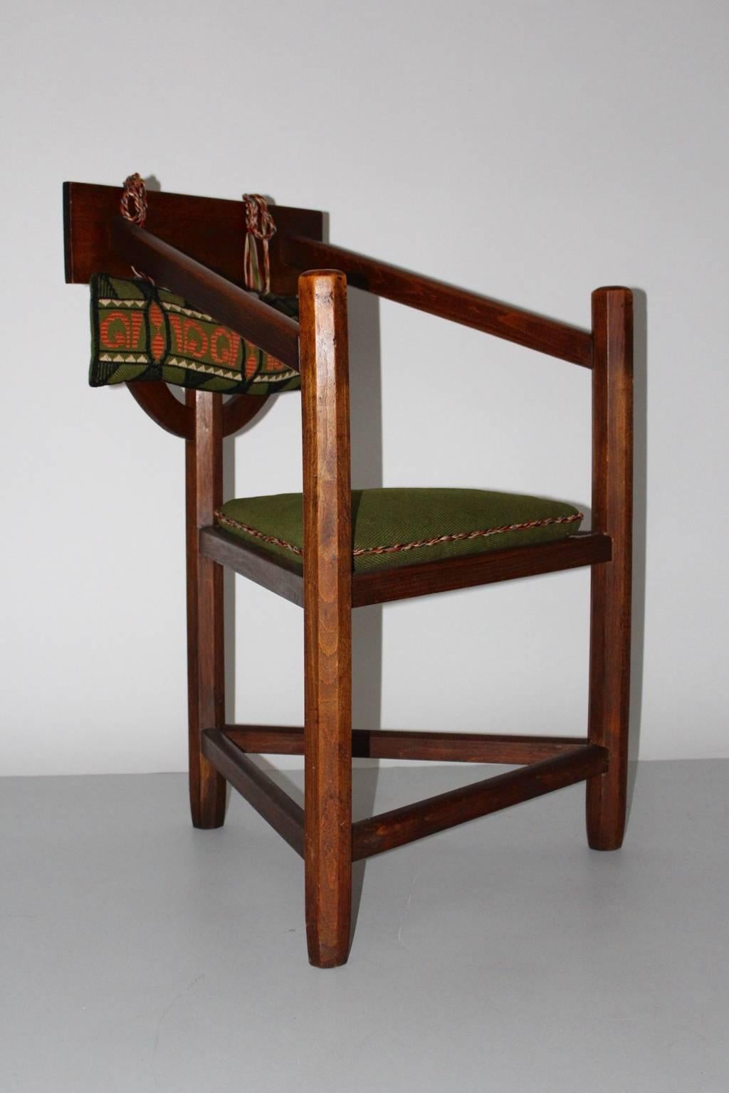 Art deco vintage rustic armchair from beech 1920s Sweden. 
A beautiful freestanding armchair with three legs and triangle like seat with loose green stitched fabric cushion. 
The rustic armchair features hand carved details at the back. Rustic