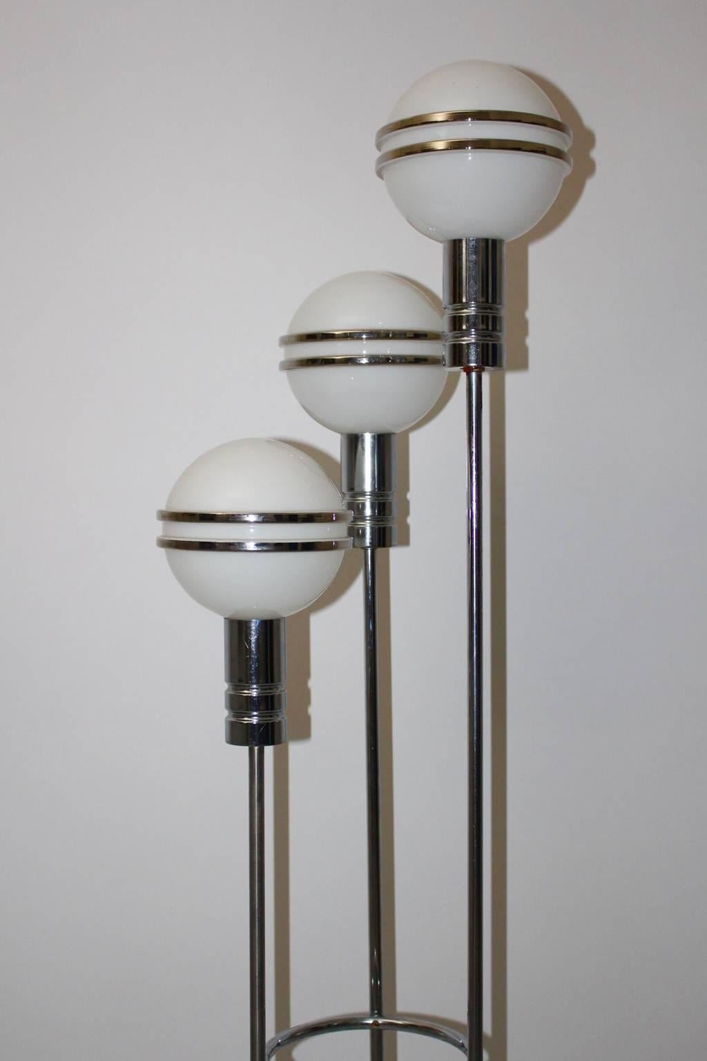 Art Deco chrome plated steel streamline Floor Lamp with three white milk-glass globes with socket E 14 and each globe shows decoration with two silver linings.
All measures are approximate.