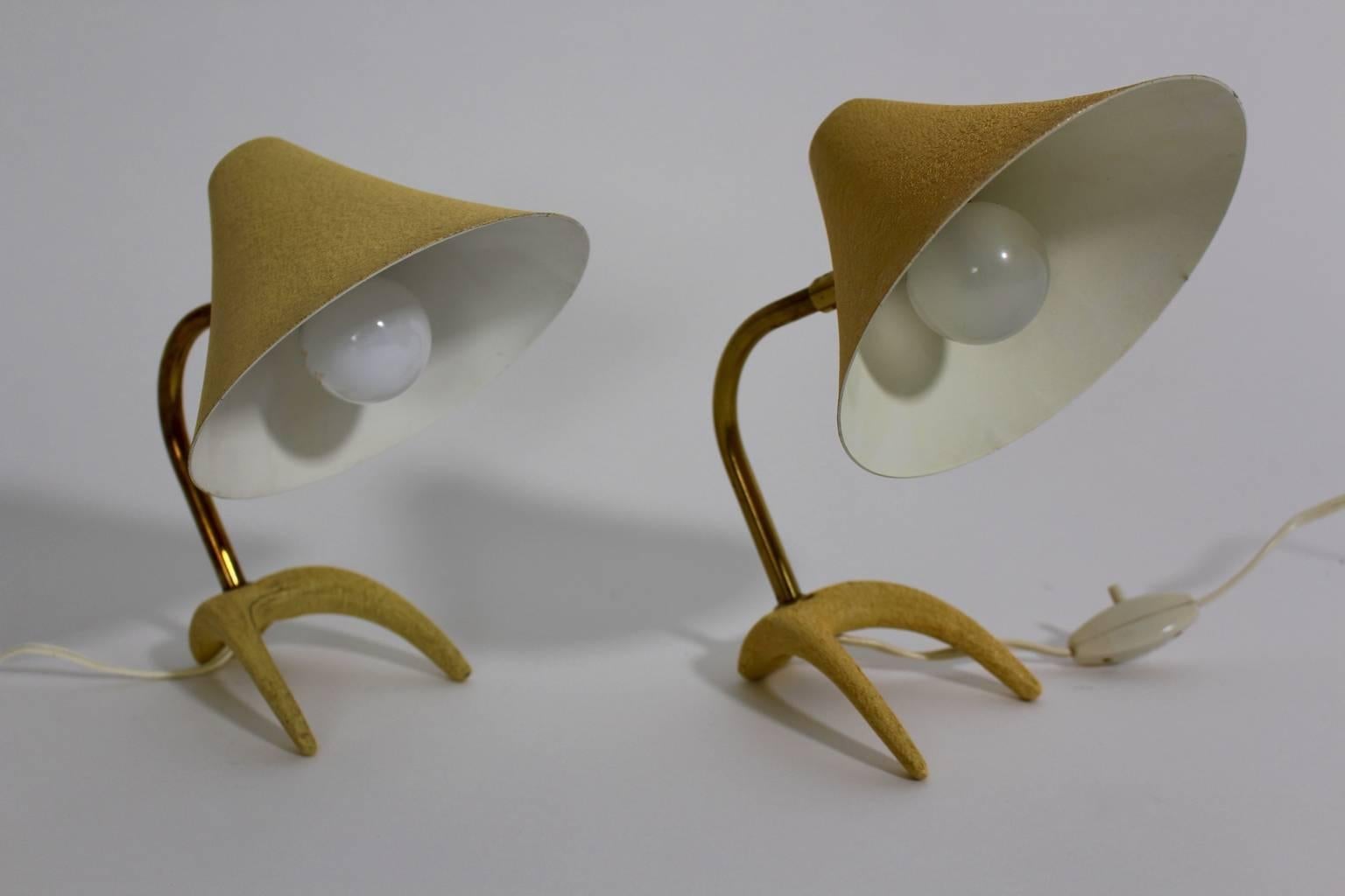 Mid-Century Modern vintage table lamps or nightstand lamps in the color soft yellow by Louis Kalff for Philips, 1950s.
A stunning pair of table lamps or nightstand lamps in the flattering color tone soft yellow.
The table lamps feature cast iron