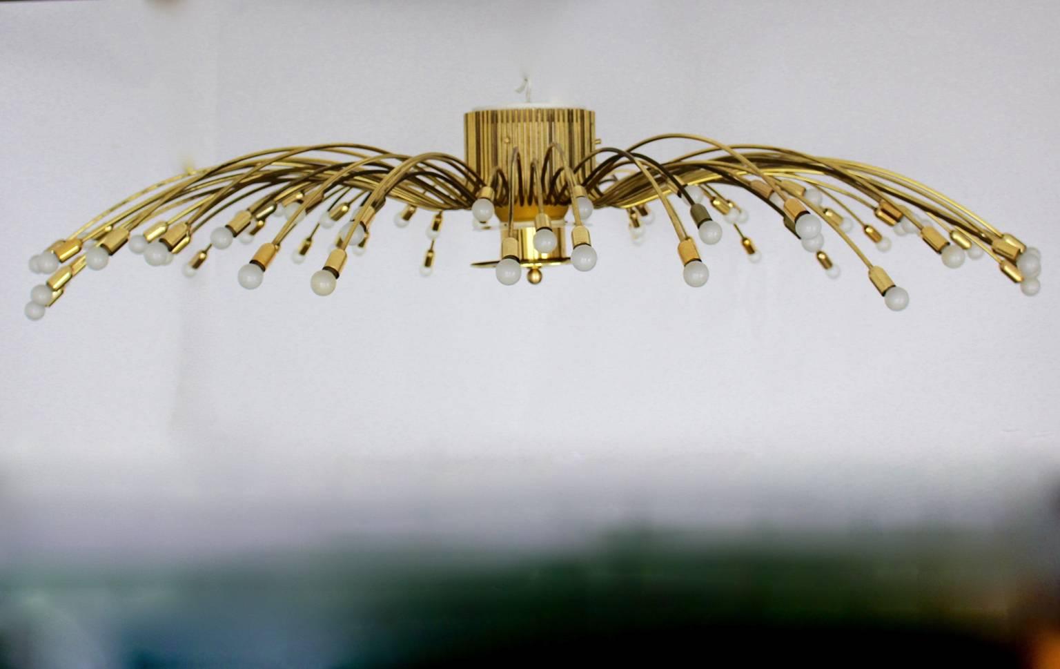 A Mid Century Modern vintage oversize brass flush mount by Kalmar Vienna, circa 1950, which shows with 72 arms 
and 72 sockets E14 .

Huge sunburst chandelier original 1950s by Kalmar with the measure: 96.46 in ( 245 cm) !
The brass arms have three