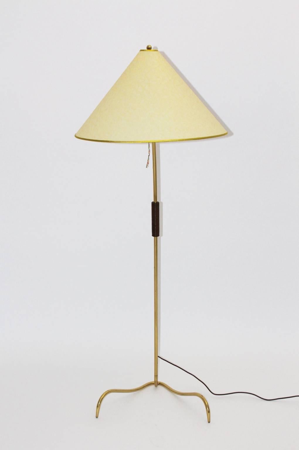 This presented floor lamp has a brass stem with a beechwood handle, brown stained. The design and the production is attributed to J. T. Kalmar, 1950s, Vienna.
The foot looks like a claw.
The parchment shade is renewed.
On/Off switch.
One socket