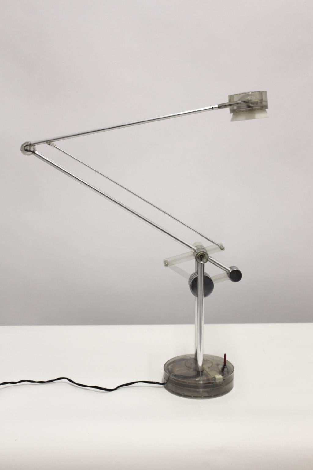 Desk lamp designed by De Pas, D'urbino and Lomazzi 1980s, Italy and produced by Valenti, Milano, Italy.

The presented desk lamp is an adjustable and revolving halogen lamp.
Chromed metal, clear plexi, glass
A special feature: the lamp is