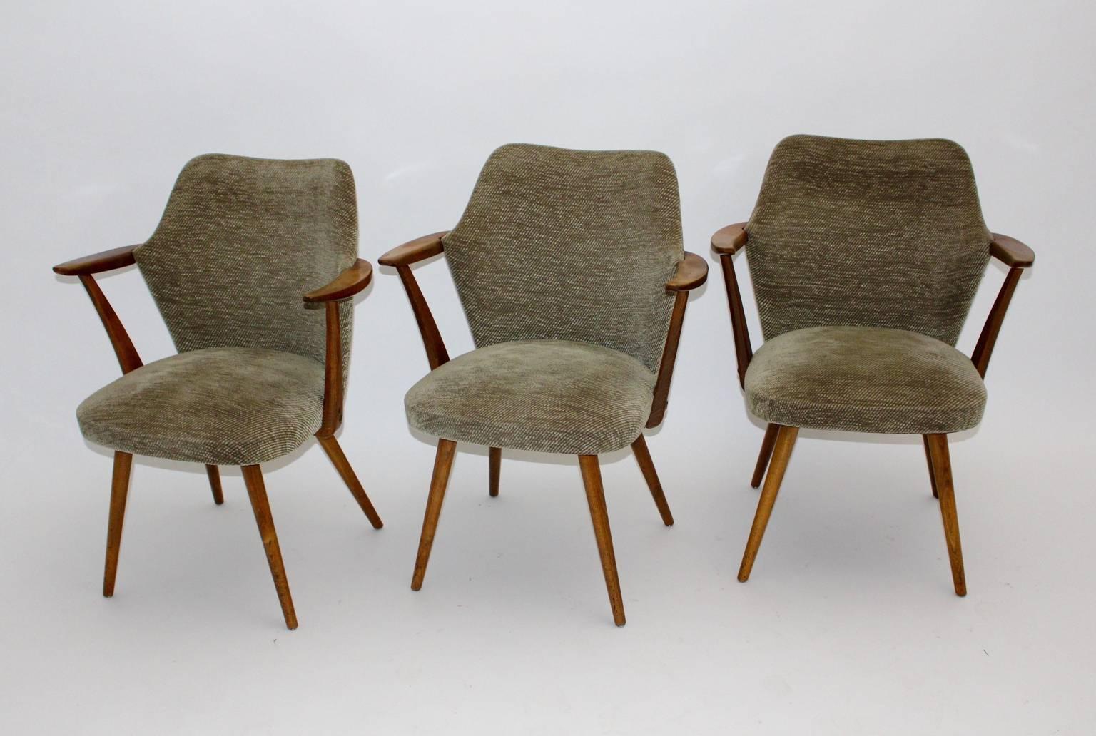 Mid century modern vintage armchairs or club chairs from beech designed by Oswald Haerdtl attributed Vienna 1950s.
The frame of the armchair is from beechwood, while the original upholstery is covered with an original woolen light-brown fabric. 
The