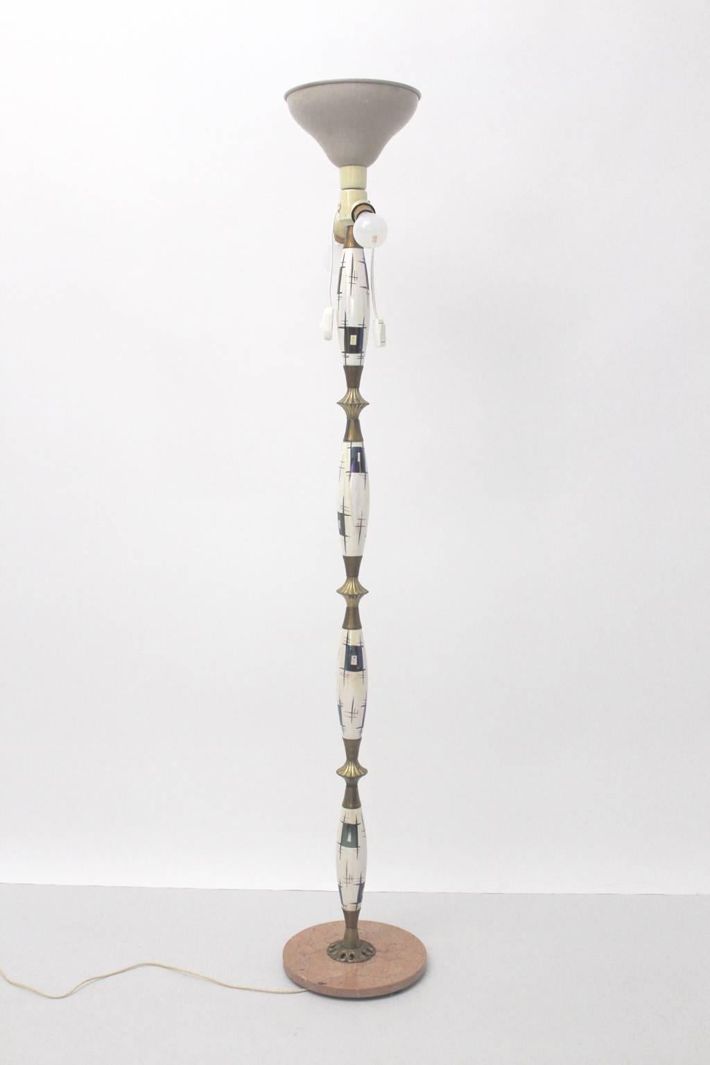 Mid Century Modern vintage floor lamp from marble and porcelain designed in Italy 1940s.
While the base consists of a disc made of marble, the stem was made of hand-painted porcelain with brass fittings and the upper part consists of an uplighter