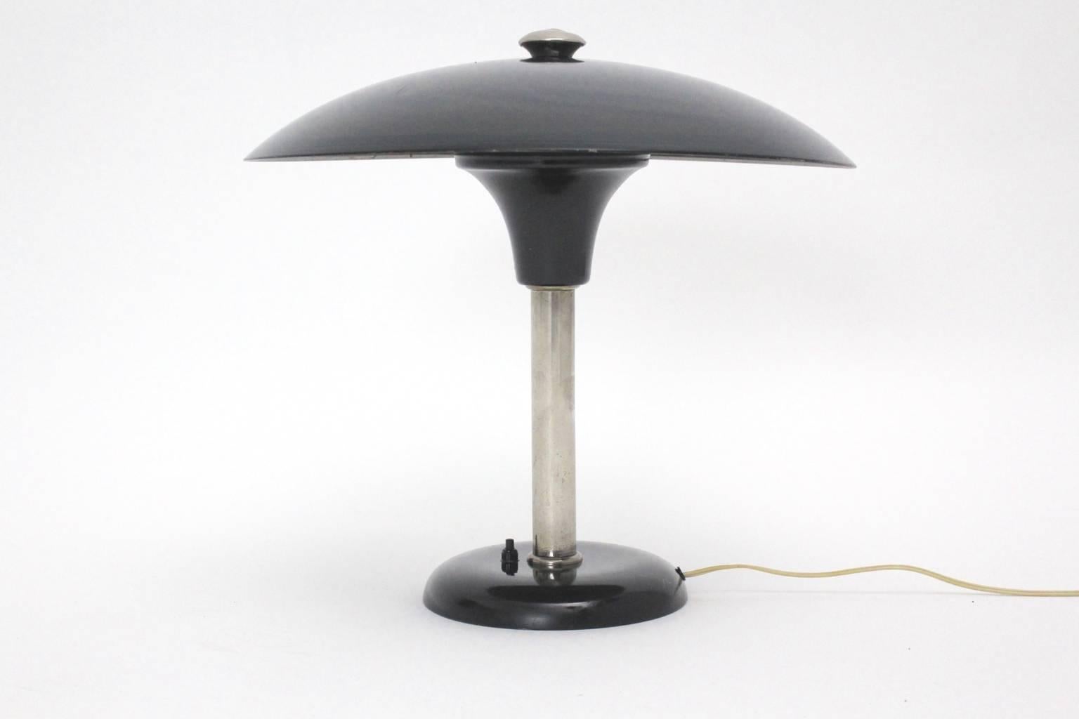 Art Deco black metal vintage Bauhaus table lamp designed by Max Schumacher and executed by Werner Schroeder, Lobenstein, Germany.
The table lamp from chromed metal and black lacquered metal is marked underneath MSW.
Very good original condition with