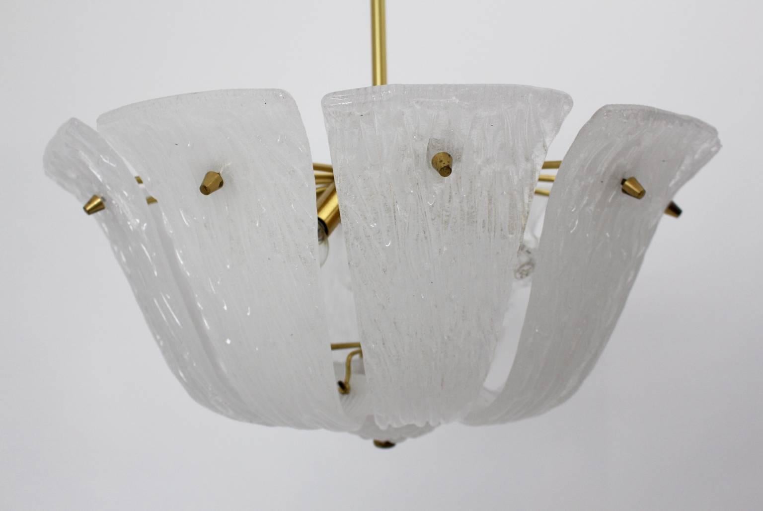Mid century modern vintage chandelier, which was designed and made by J. T. Kalmar.
Beautiful white curved glass leaves well - formed to a lamp shade.
While the chandelier was created with ten brass arms and white textured Murano glass shades, it
