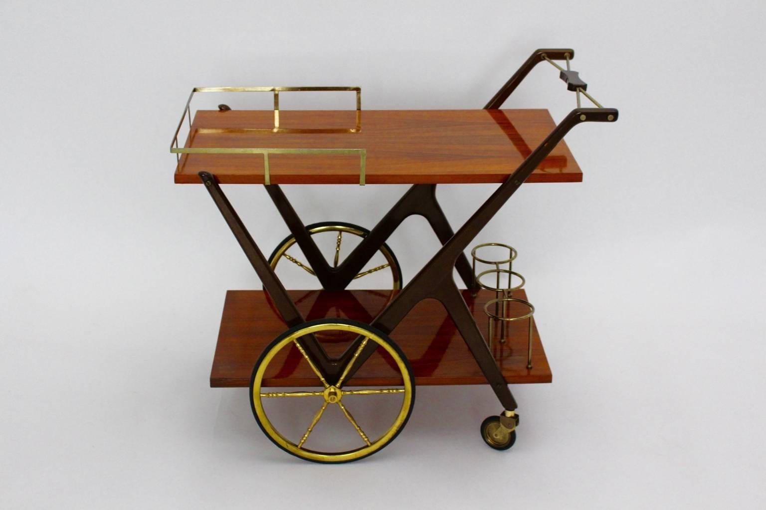 This elegant bar cart was designed by Cesare Lacca, Italy, 1950s.
The serving tables features two walnut veneered tiers and also four brass wheels and wood brown lacquered parts.
The vintage condition is very good.
All measures are
