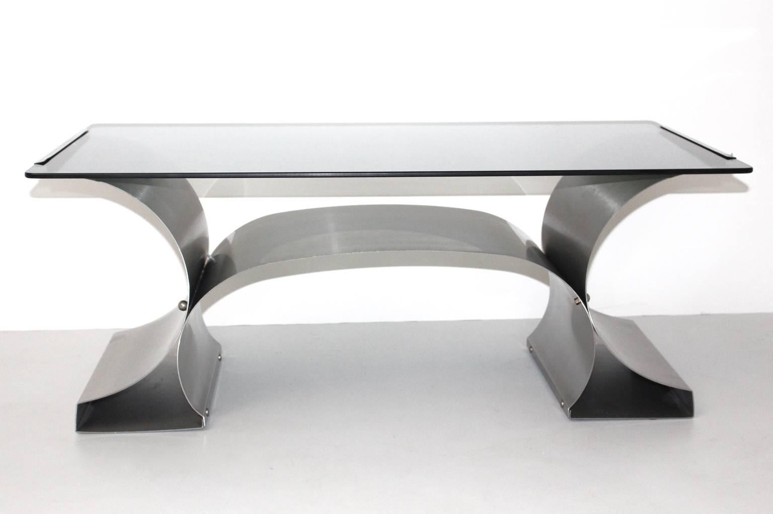 Coffee table designed by Francois Monnet, circa 1970, France.

Made of brushed stainless steel with an integrated glass top in
very good vintage condition.
All measures are approximate.
                      