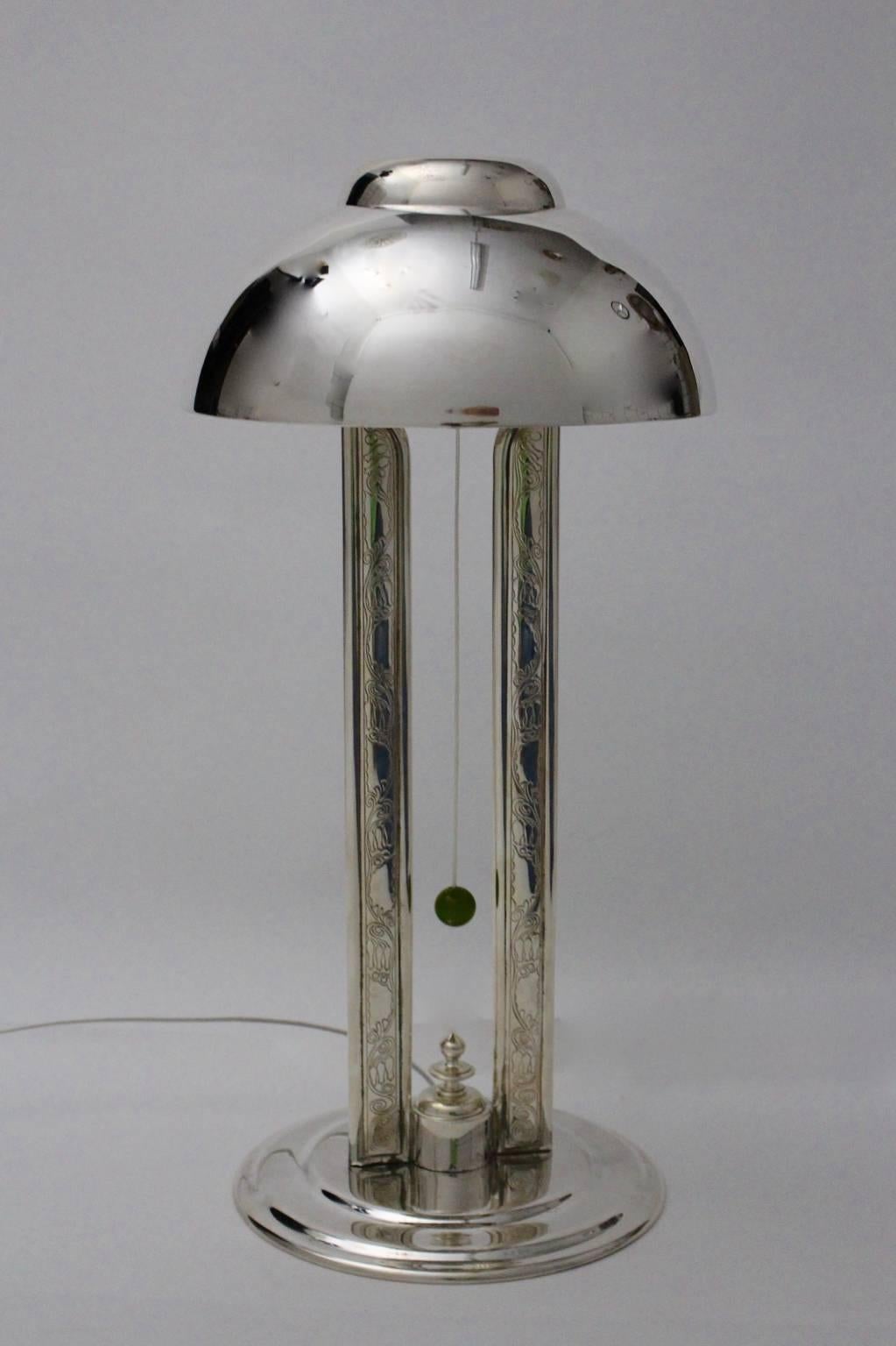 Rare elegant handmade table lamp, which is silver plated and partly provided with ornaments on the pilaster stripes.

Also the table lamp shows a pull switch with a green bakelite ball.
Additionally the table lamp features one socket E 27.
Best