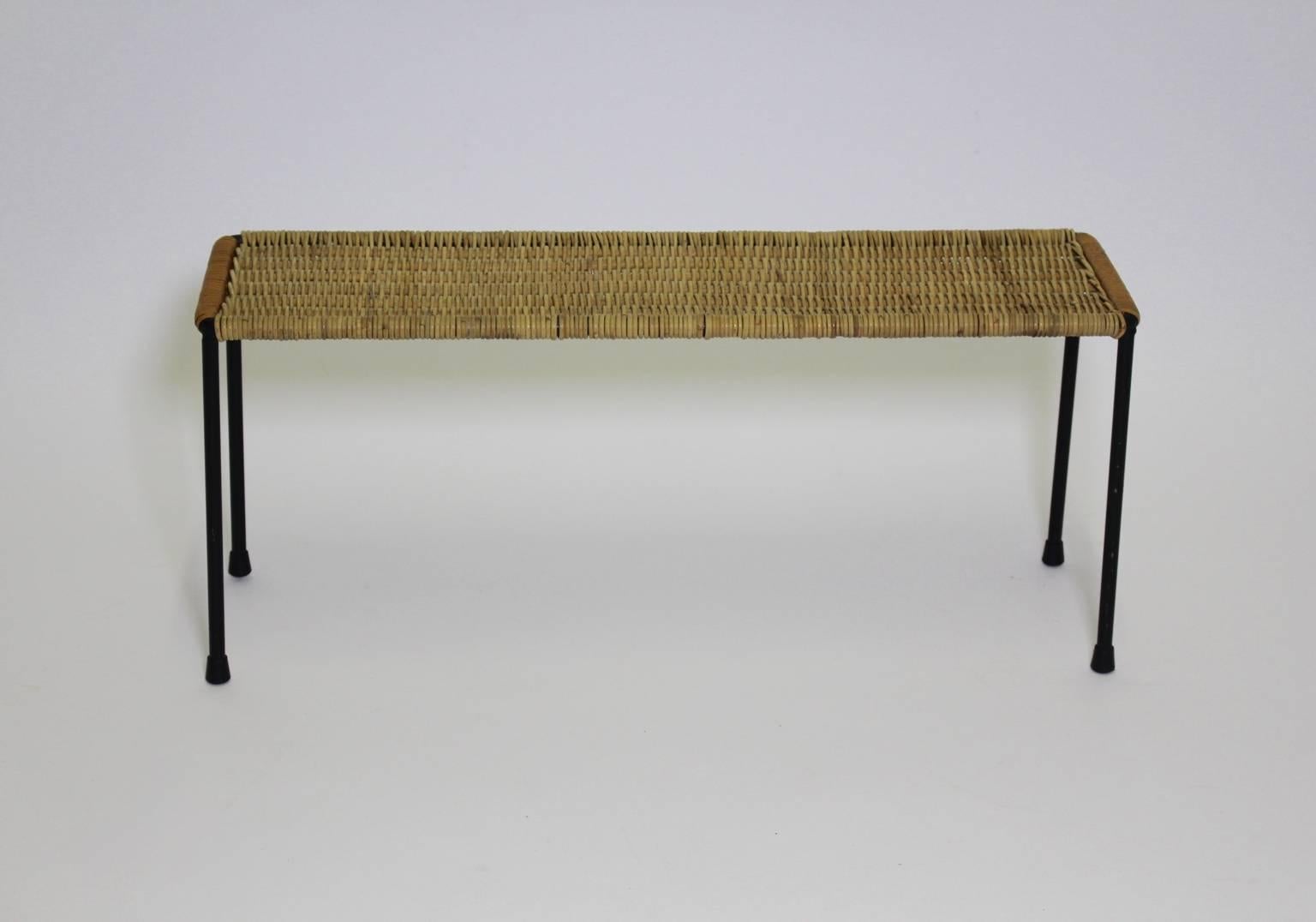 Mid century modern vintage side table of sofa table from rattan and steel designed by Carl Auböck circa 1950s. The side table shows a black painted steel frame and an original wicker top in very good condition.
The side table was designed by Carl