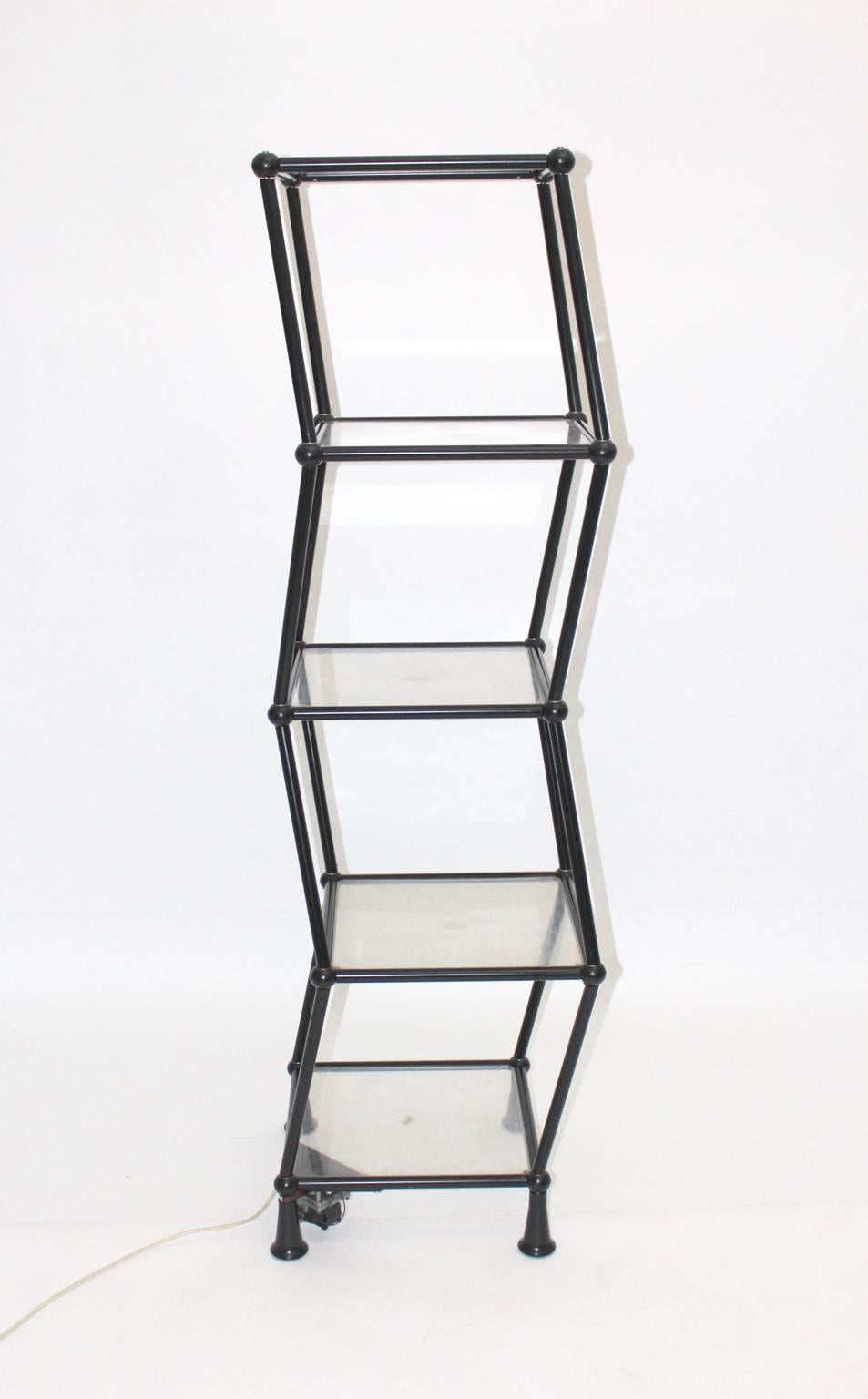 Space Age vintage dancing shelf from tube steel and plexiglass. The dancing shelf features a black lacquered tube steel base and 
five plexiglass plates. Furthermore the shelf shows 20 ball joints and four tiers.
The shelf works with an electric
