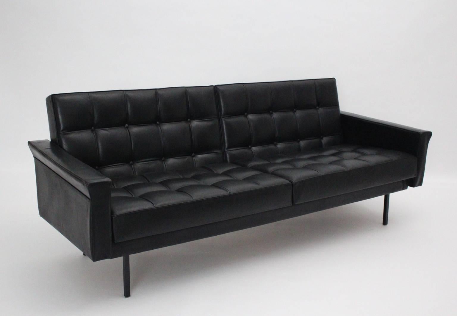 Mid Century Modern black vintage leather sofa or bench by Johannes Spalt circa 1960 Vienna.
The freestanding black leather sofa shows tufted leather stitching with buttons.
Two loose seat cushions and two loose back cushions promise a comfortable