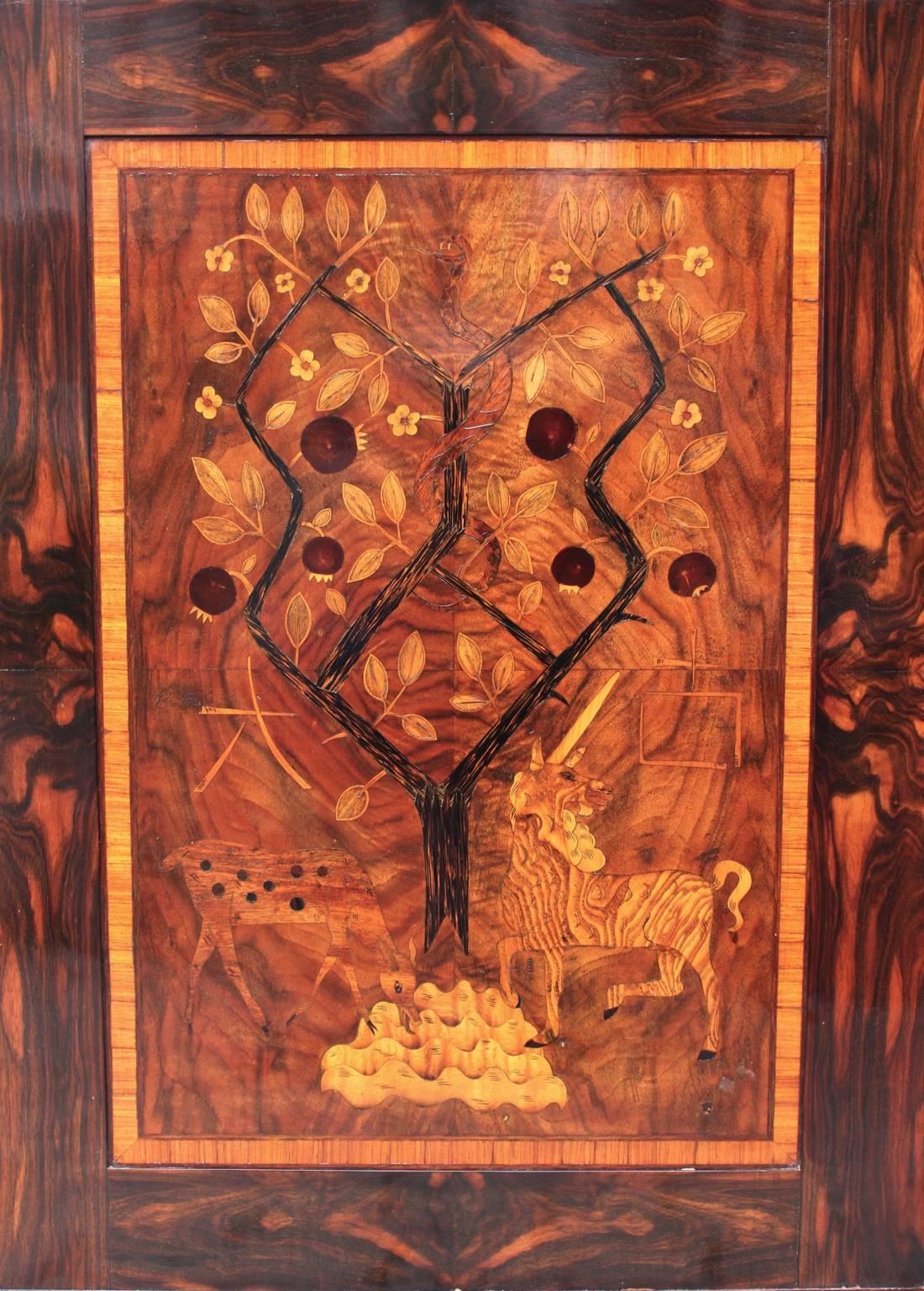 An art deco inlaid vintage picture, which shows a scene from the paradise with Adam and Eve.

The wooden picture was made out of various kinds of wood e.g. palm wood, rosewood, walnut, ash wood and maple tree.
All measures are approximate.
Please