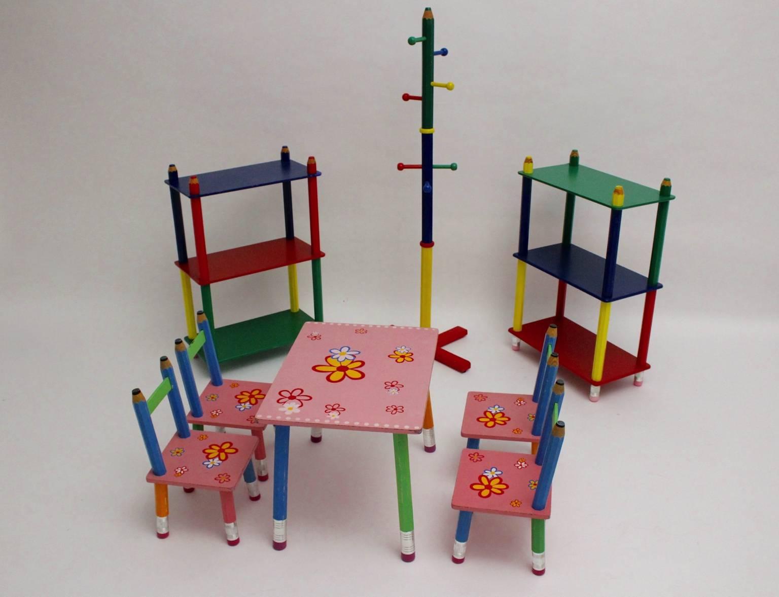 Postmodern vintage multicolored children sitting room set. The set consists of one table, four chairs,pair of wall shelves and a coatrack in the colors pink, green, blue, red and yellow.
Designed by Pierre Sala, France (1948-1989) in the 1980s, and