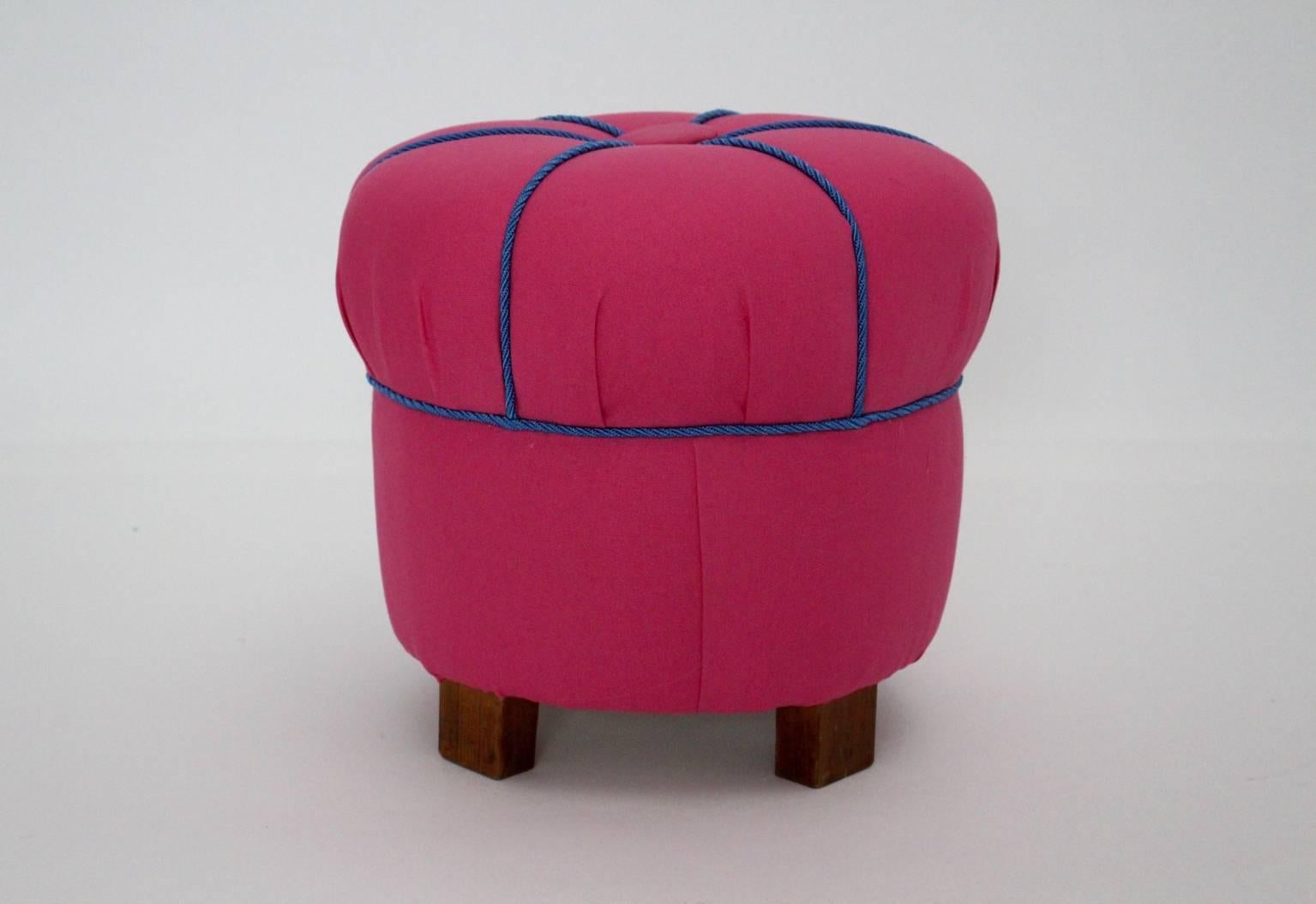 A charming art deco pink textile pouf / stool or tabouret,  Austria, 1930s.
The stool is newly covered with a high quality pink fabric and decorated with blue cords.
The stool has beechwood feet.

The condition is very good.
 All measures are