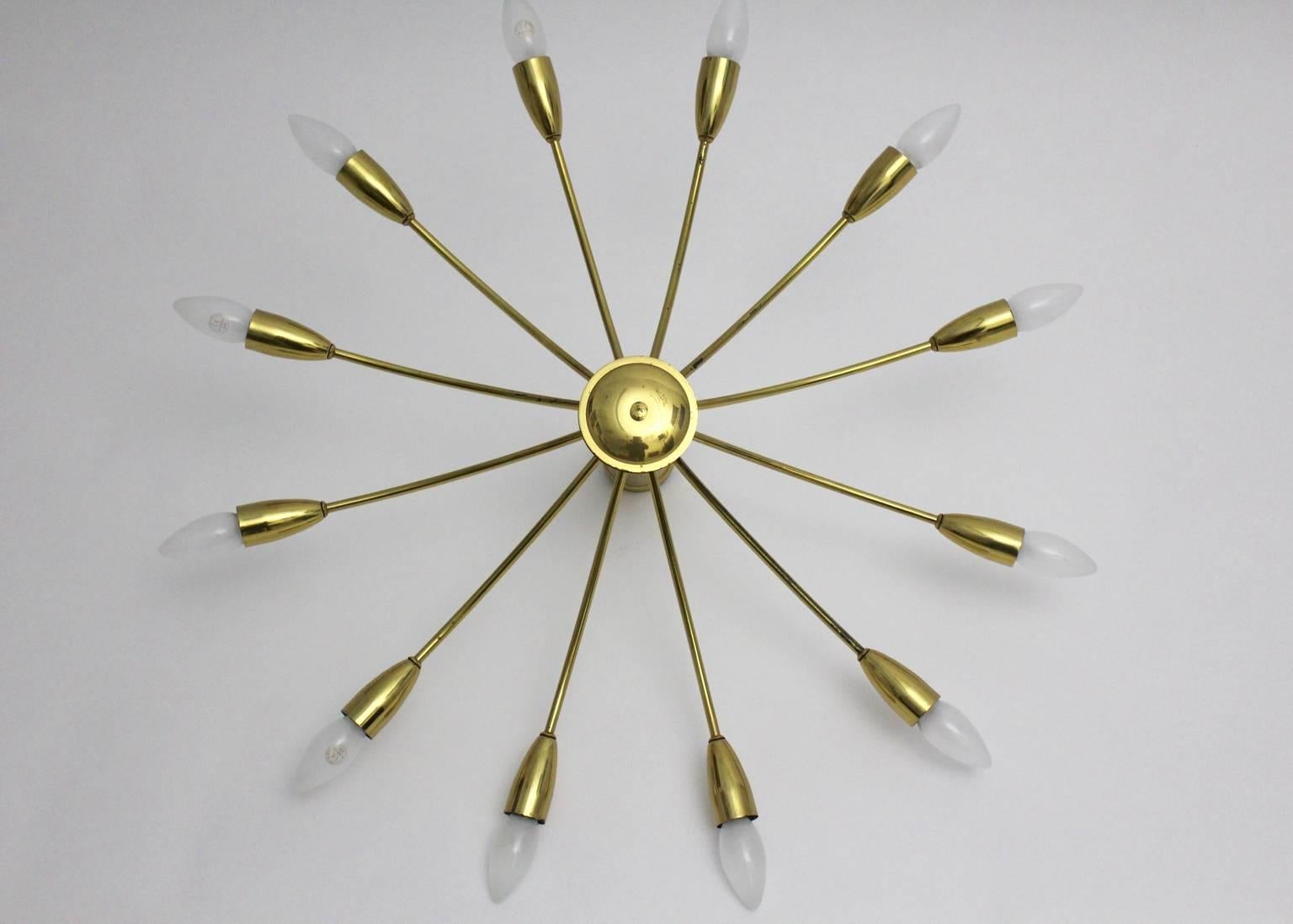 This presented flush mount was made of curved polished brass and features 12-arms with 12 sockets E 14.
Also the shape is elegant and looks like sunbursts.
The  lighting was designed and executed by Kalmar, Austria 1950s.

The flush mount is in very