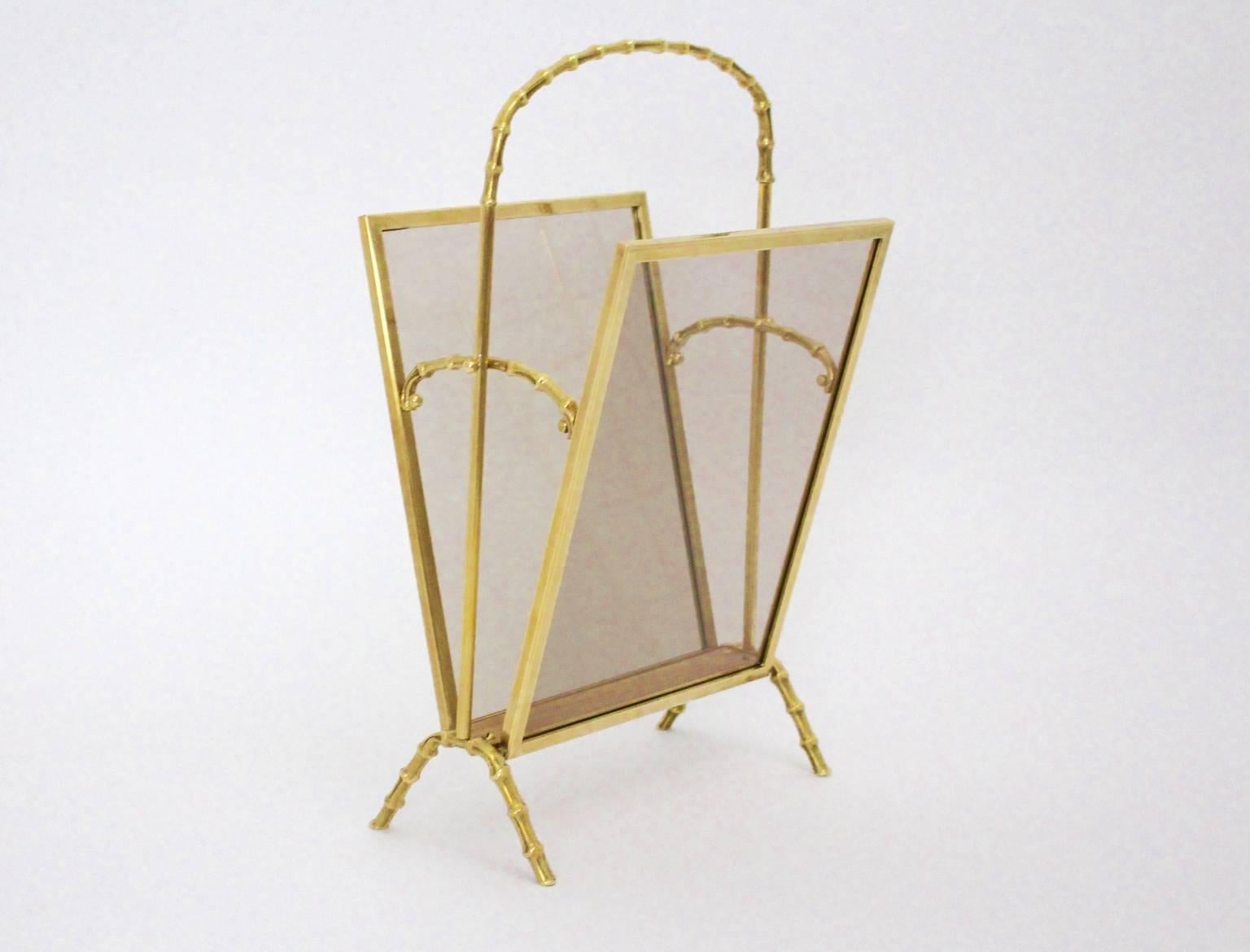Mid Century Modern vintage faux bamboo newspaper rack or magazine rack by Maison Bagues, 1940s France.
An amazing newspaper rack from solid brass and smoked glass bamboo like.
This magazine rack consists of solid polished brass frame and two smoked