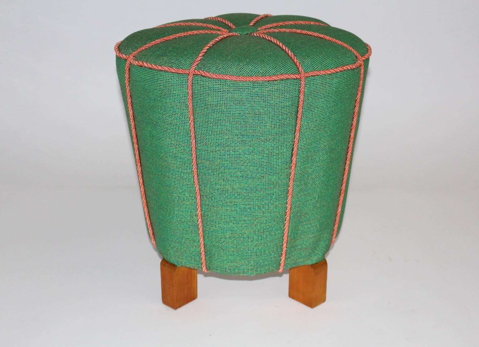 This presented elegant Stool or Tabouret features a very charming curved shape.
The original upholstery is newly covered with a luxurious green textile fabric furthermore salmon-pink cords decorates the surface.
In the middle of this Stool sits a