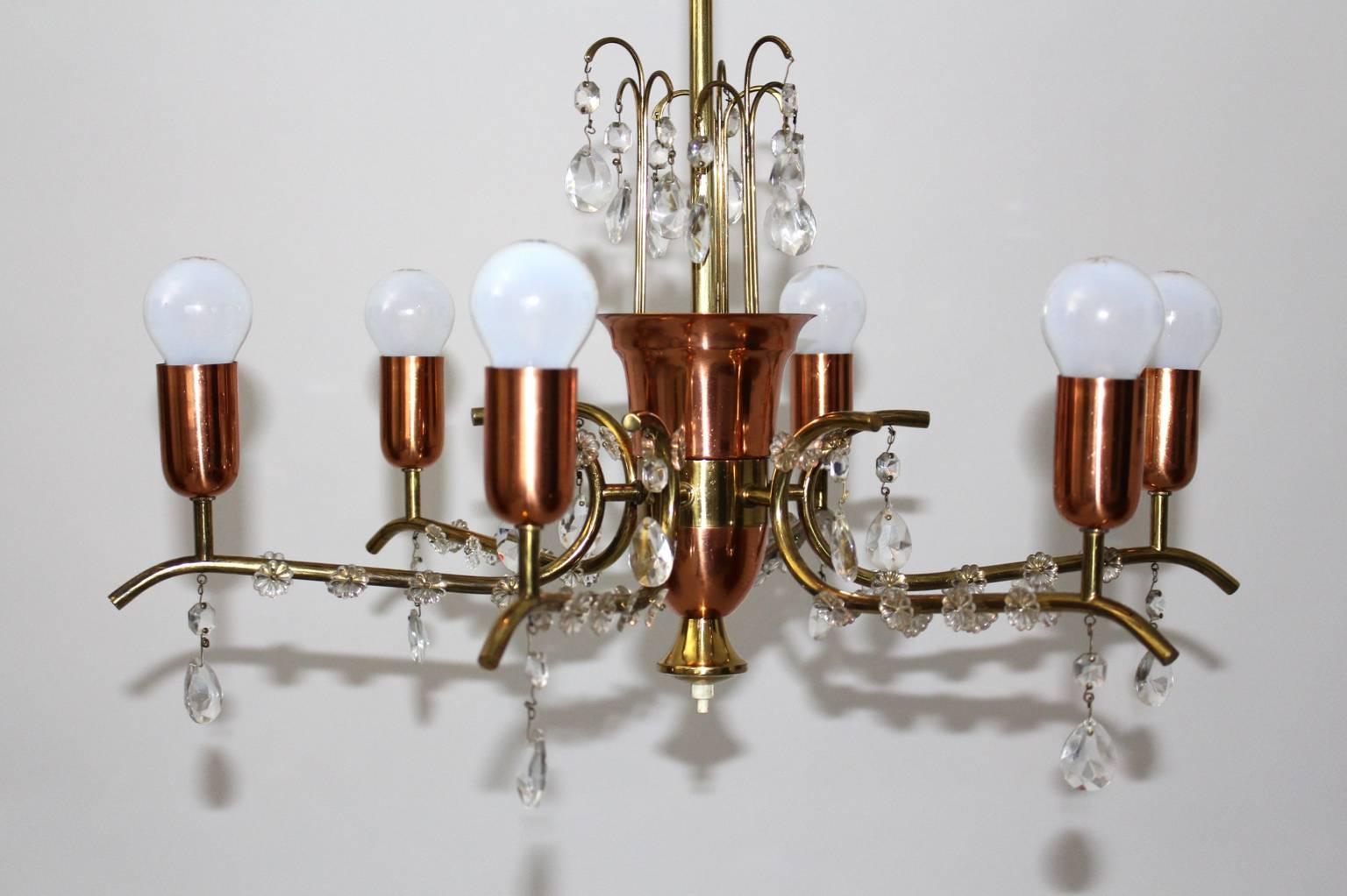 Mid Century Modern brass copper crystal chandelier by Rupert Nikoll Vienna 1950s.
The chandelier is made of brass, copper and crystal glass elements.
A beautiful link from the traditional chandeliers to the whimsical era of the 1950s.
Six sockets