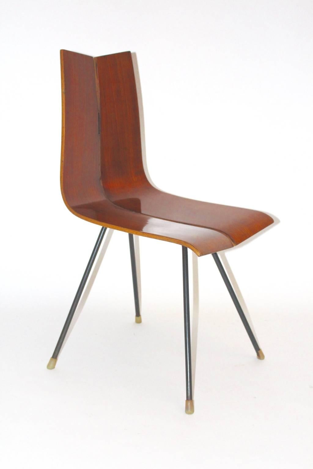 Mid Century Modernn chair or side chair designed by Hans Bellmann, circa 1955. 
Manufactured by Horgen-Glarus, Switzerland
The GA chair is made of a black lacquered tube steel base, while the seat shell made from plywood teak veneered.
The surface